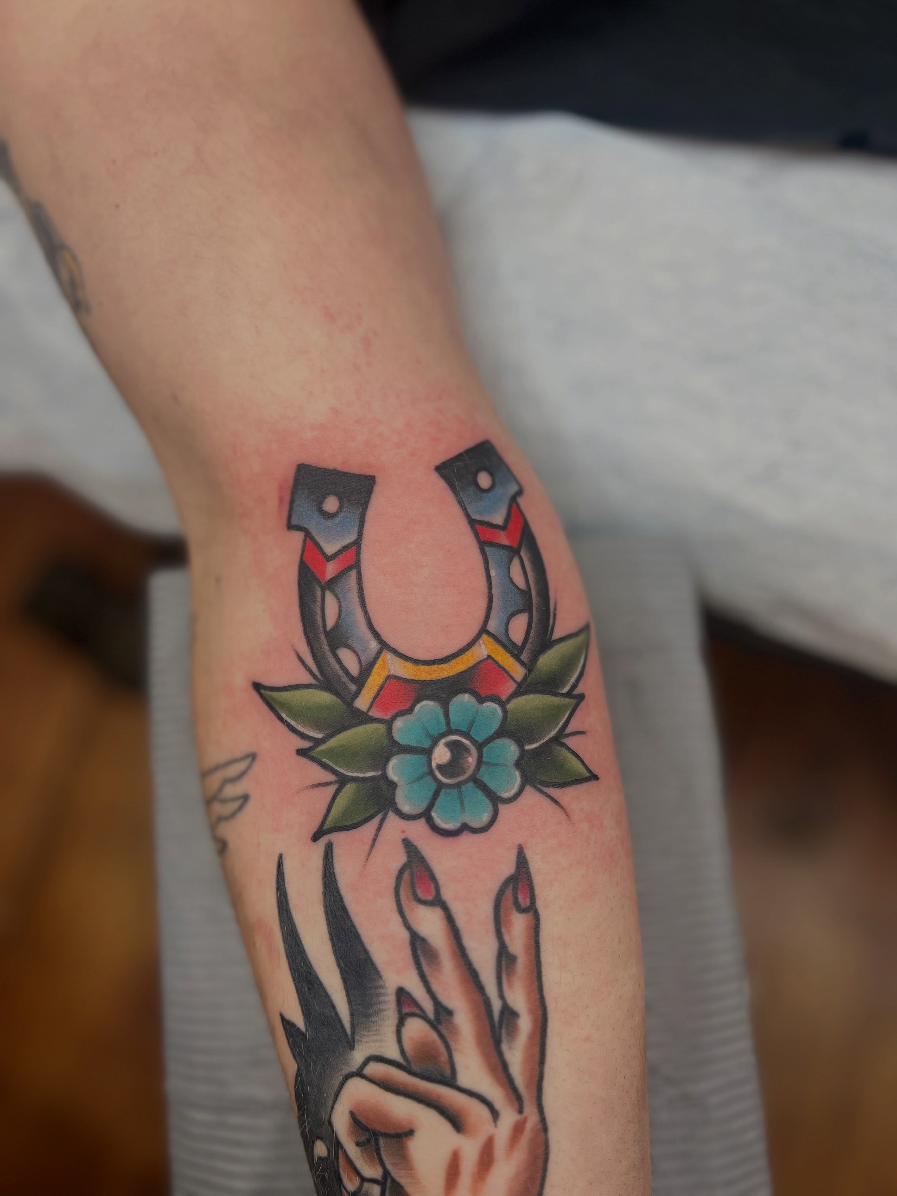 Horseshoe and flower American traditional tattoo on the forearm by Fizzy Jizzles, Worcester, England