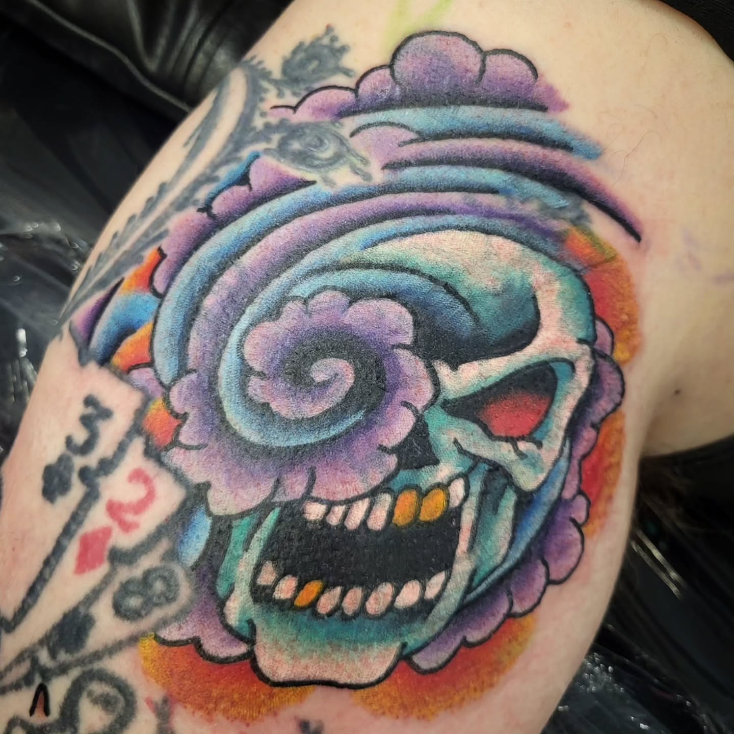 Skull American traditional tattoo on the shoulder by Sloan Smith