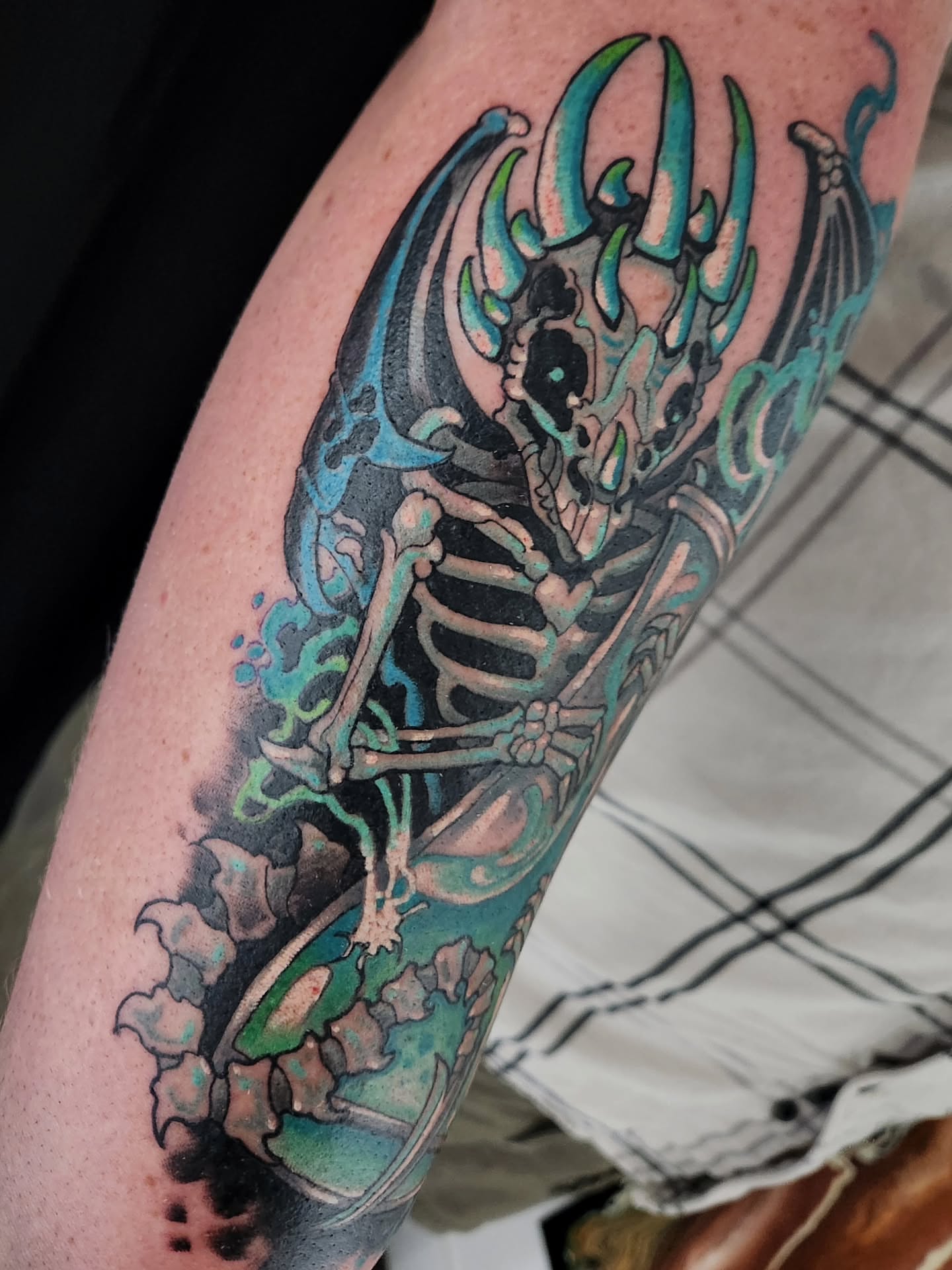 Skeleton with wings neo-traditional tattoo on the forearm by Randy