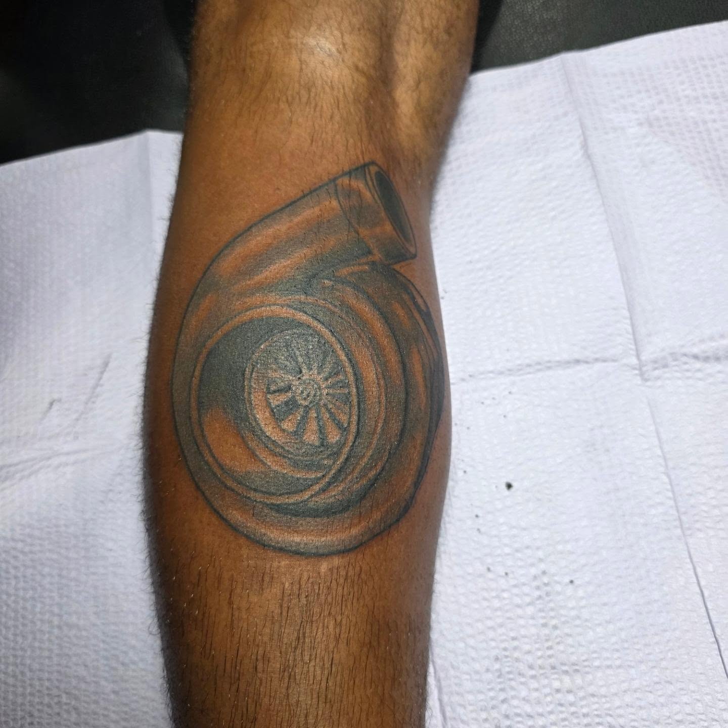 Turbocharger black and grey tattoo on the forearm by Rusty Williams