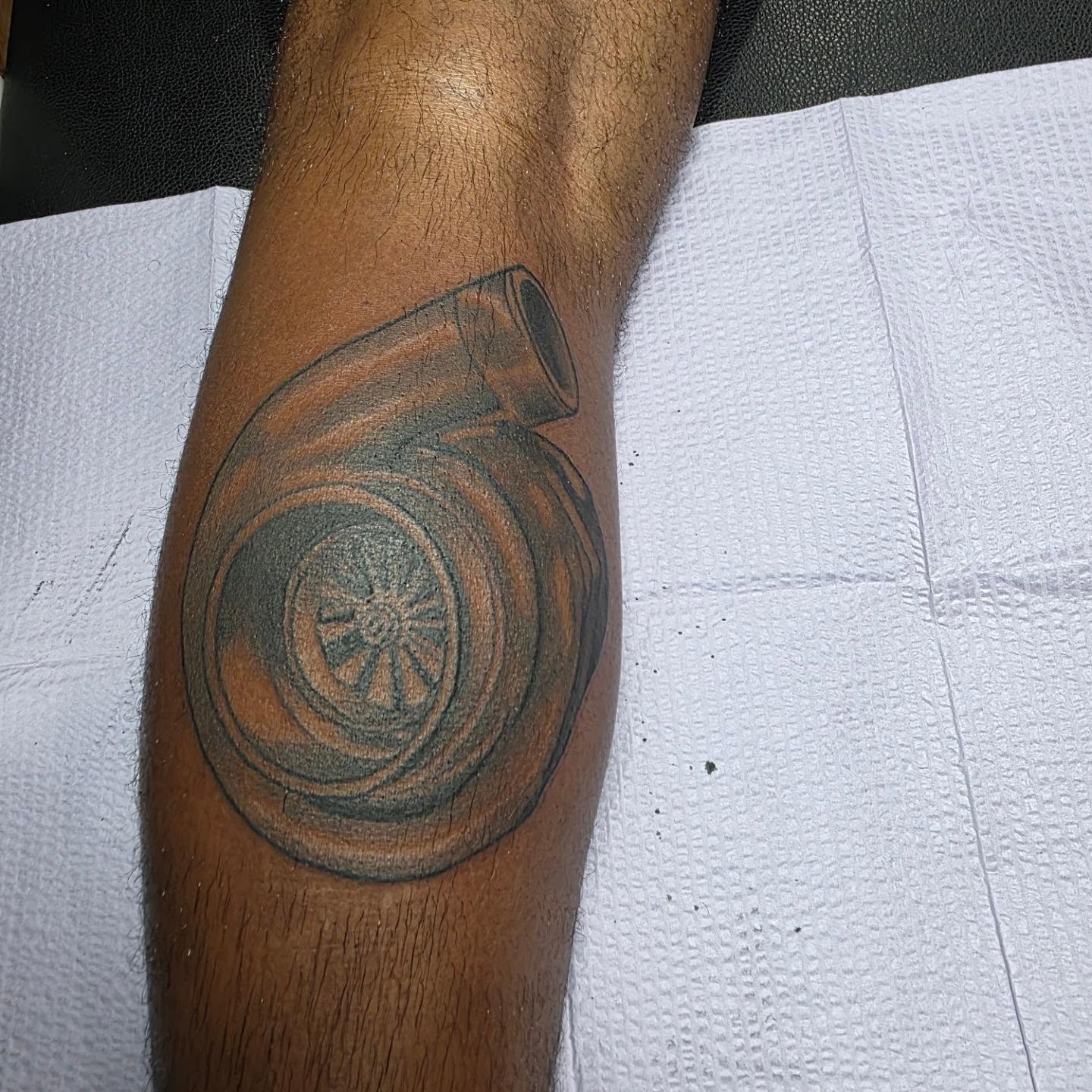 Turbocharger black and grey tattoo on the forearm by Rusty Williams