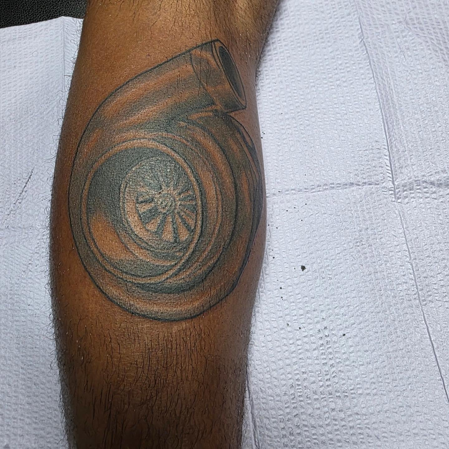 Turbocharger black and grey tattoo on the forearm by Rusty Williams