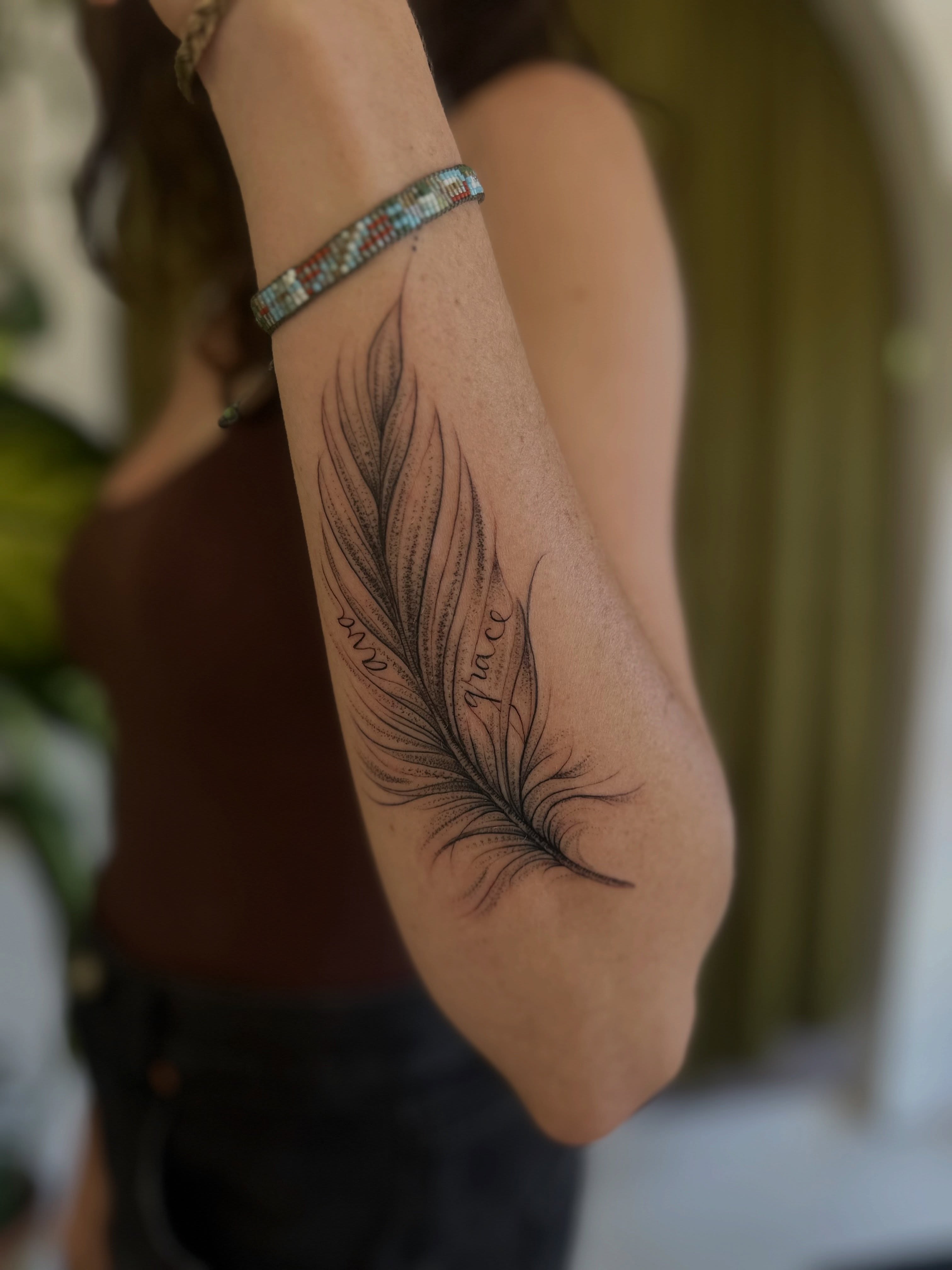 Feather dotwork tattoo on the forearm by Ric Castellon Tattoo Artist, Los Angeles, California