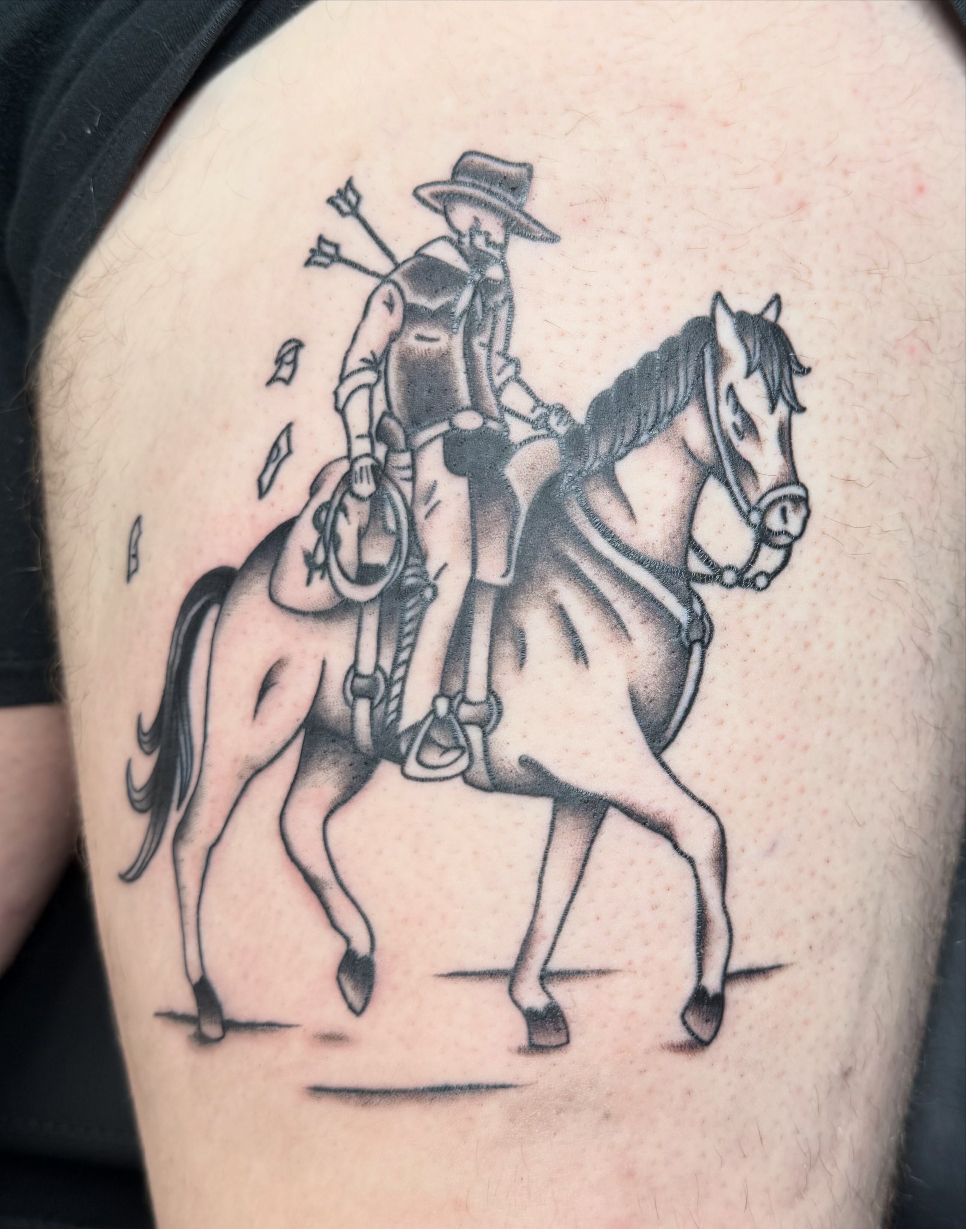Cowboy on horse black and grey tattoo on the thigh by Hunter Beyer