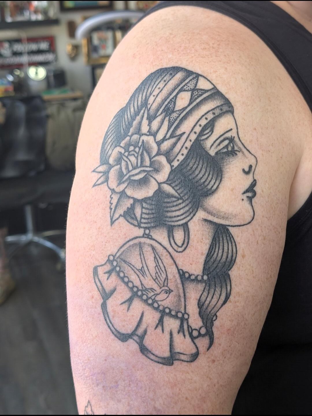 Woman with floral headpiece dotwork tattoo on the shoulder by Alexandria Green
