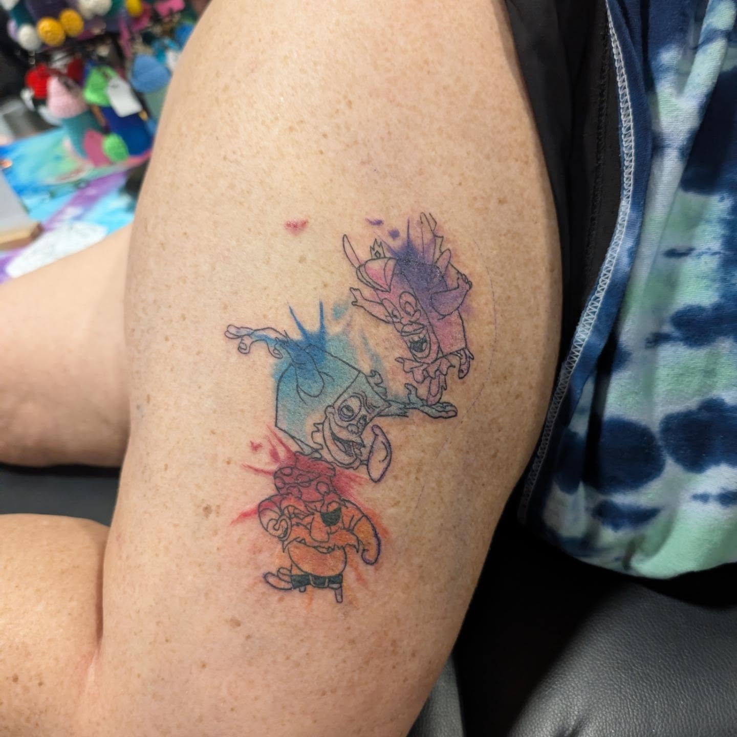 Cartoon characters watercolor tattoo on the thigh by Ben Cecil, Summerville, South Carolina