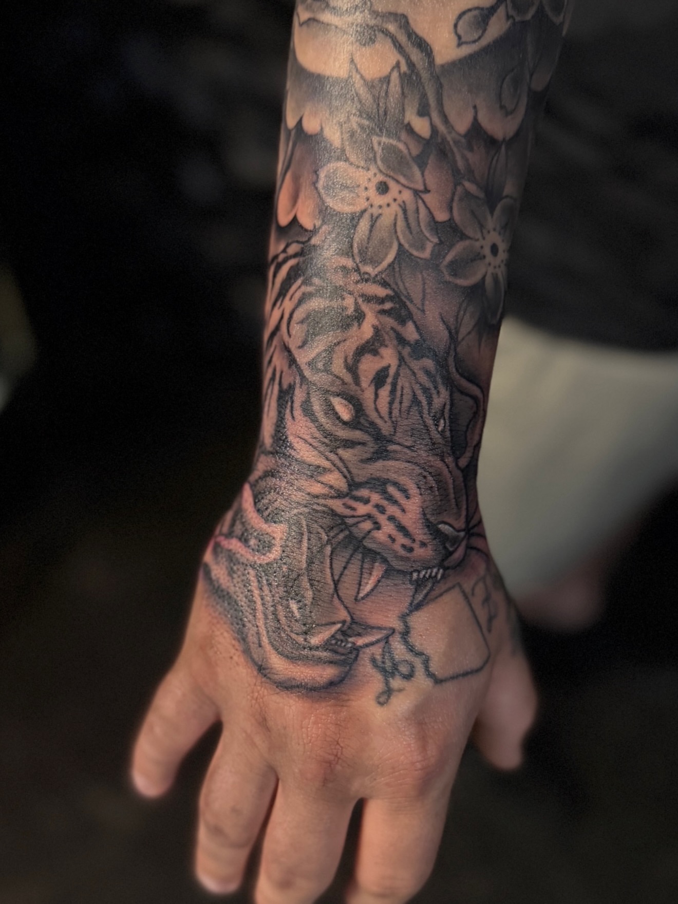 Tiger and flowers realism tattoo on the forearm by Rikky Bobby, Mesa, Arizona