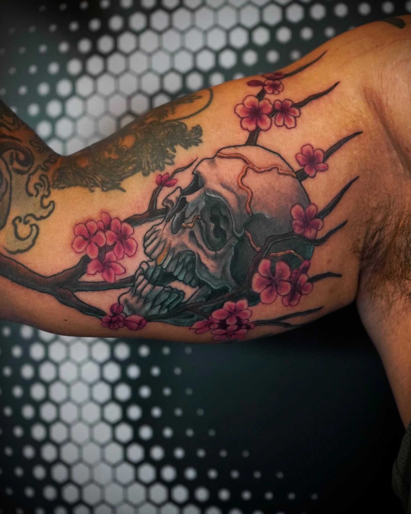 Skull and cherry blossoms japanese irezumi tattoo on the forearm by Gina Carlson
