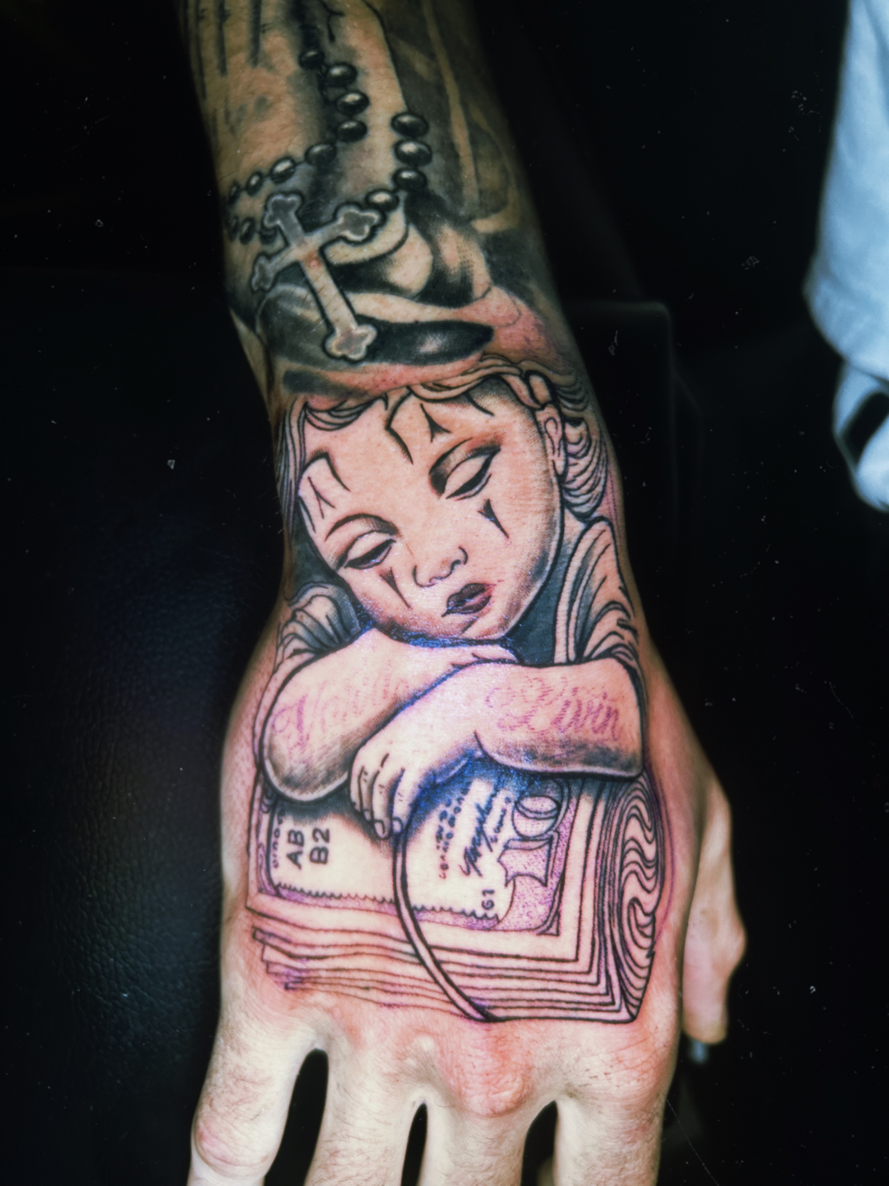 Child with cross American traditional tattoo on the hand by Tito Cross ❤️‍🔥