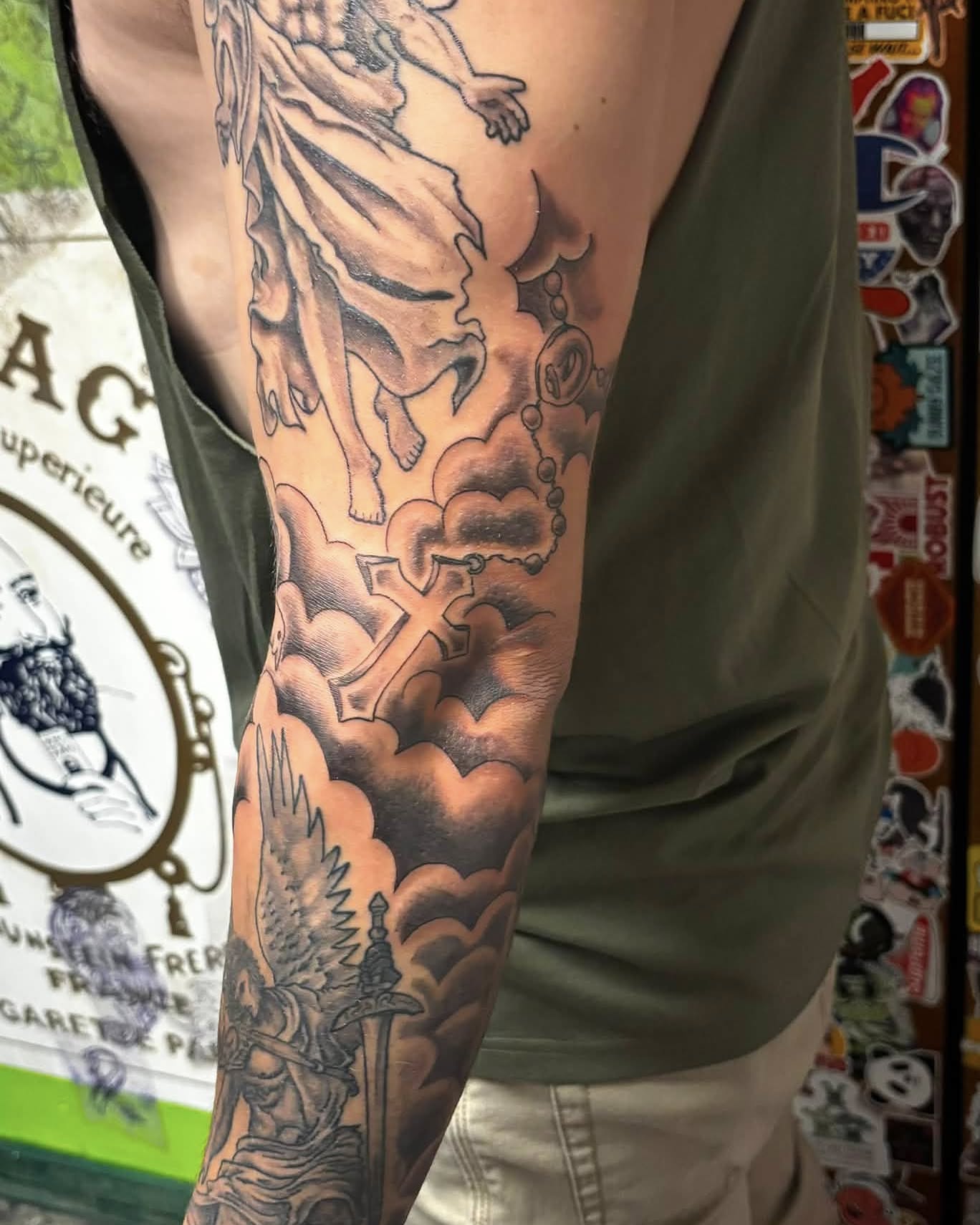 Religious iconography black and grey tattoo on the forearm by Jeff Zuptich