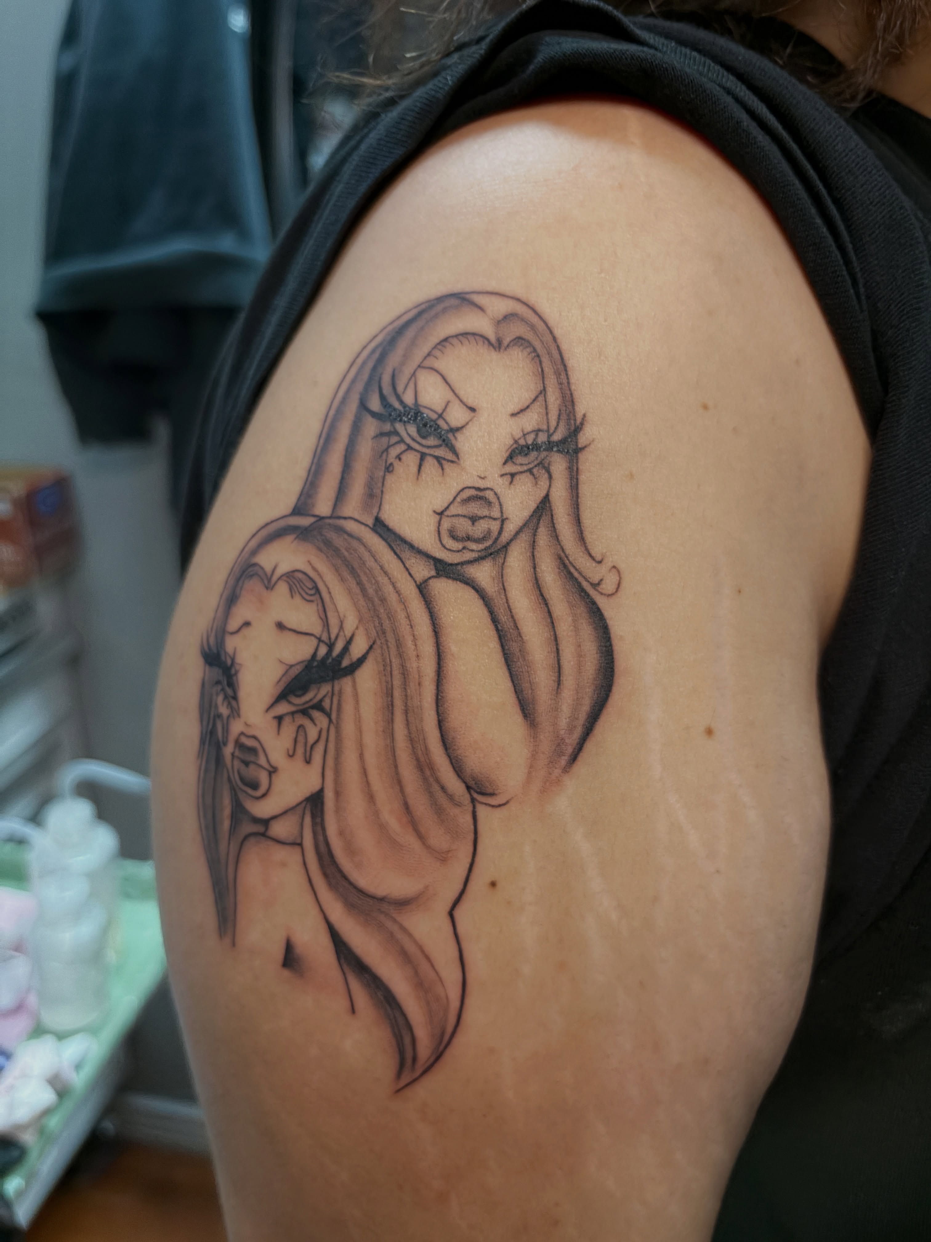 Two women black and grey tattoo on the shoulder by Destineé