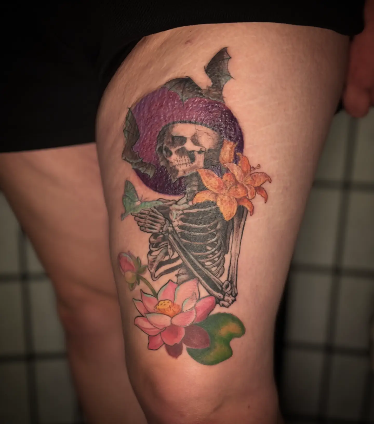 Skeleton with flowers American traditional tattoo on the thigh by Jo Xylo - Minneapolis Tattoo Artist, Minneapolis, Minnesota