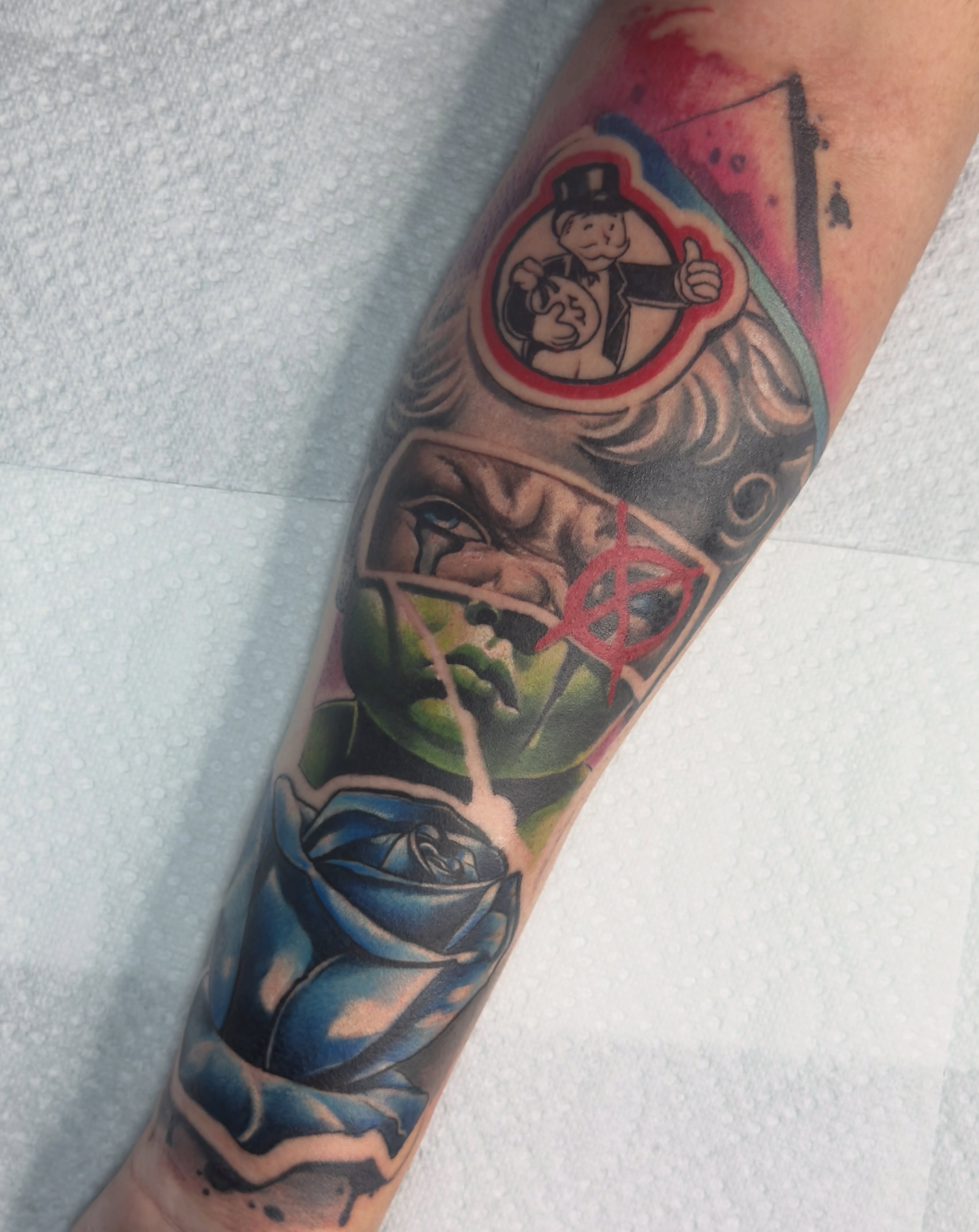 Woman with rose American traditional tattoo on the forearm by Donald Reynolds