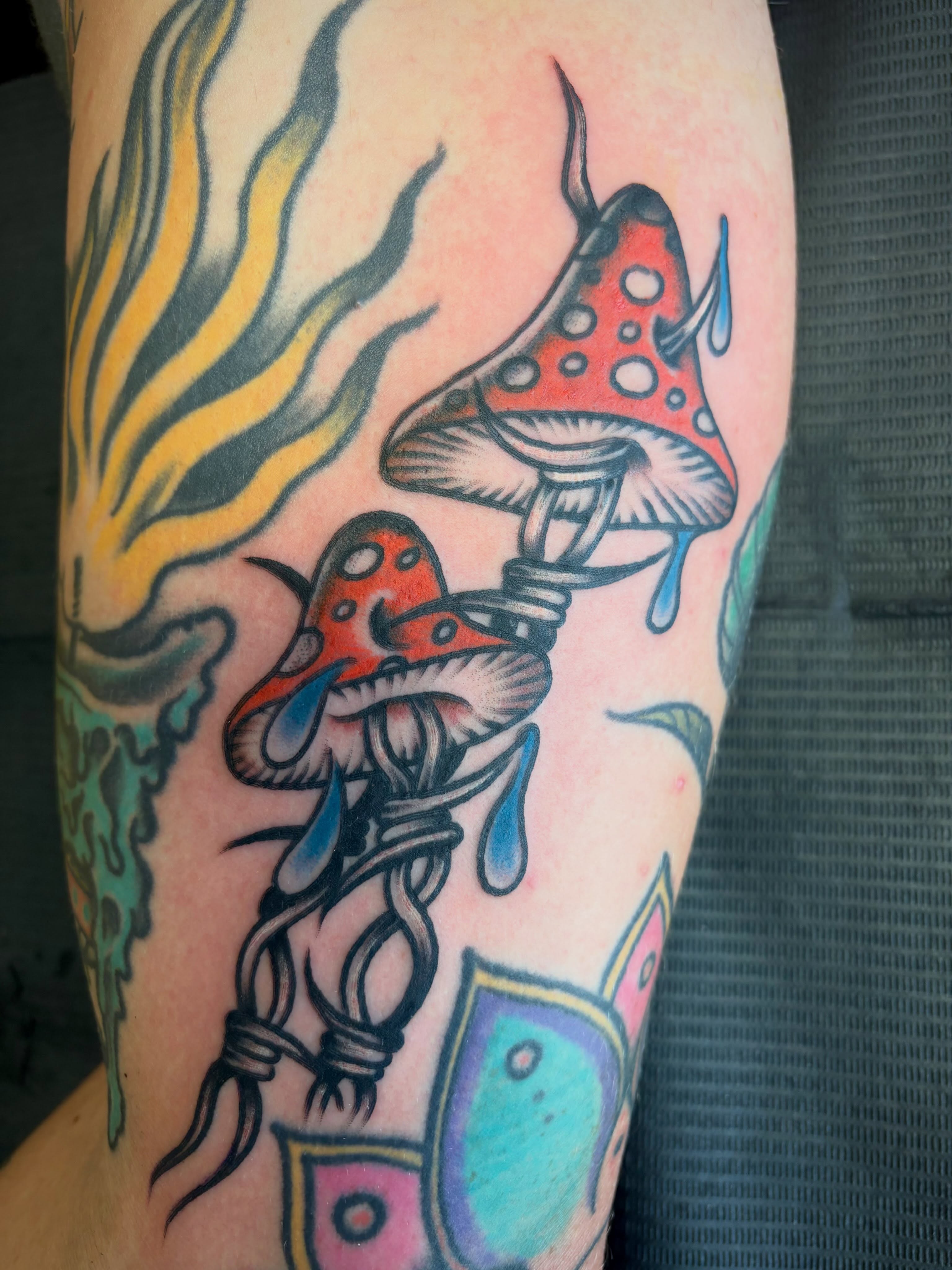 Mushrooms American traditional tattoo on the forearm by Micheal McGlinchey