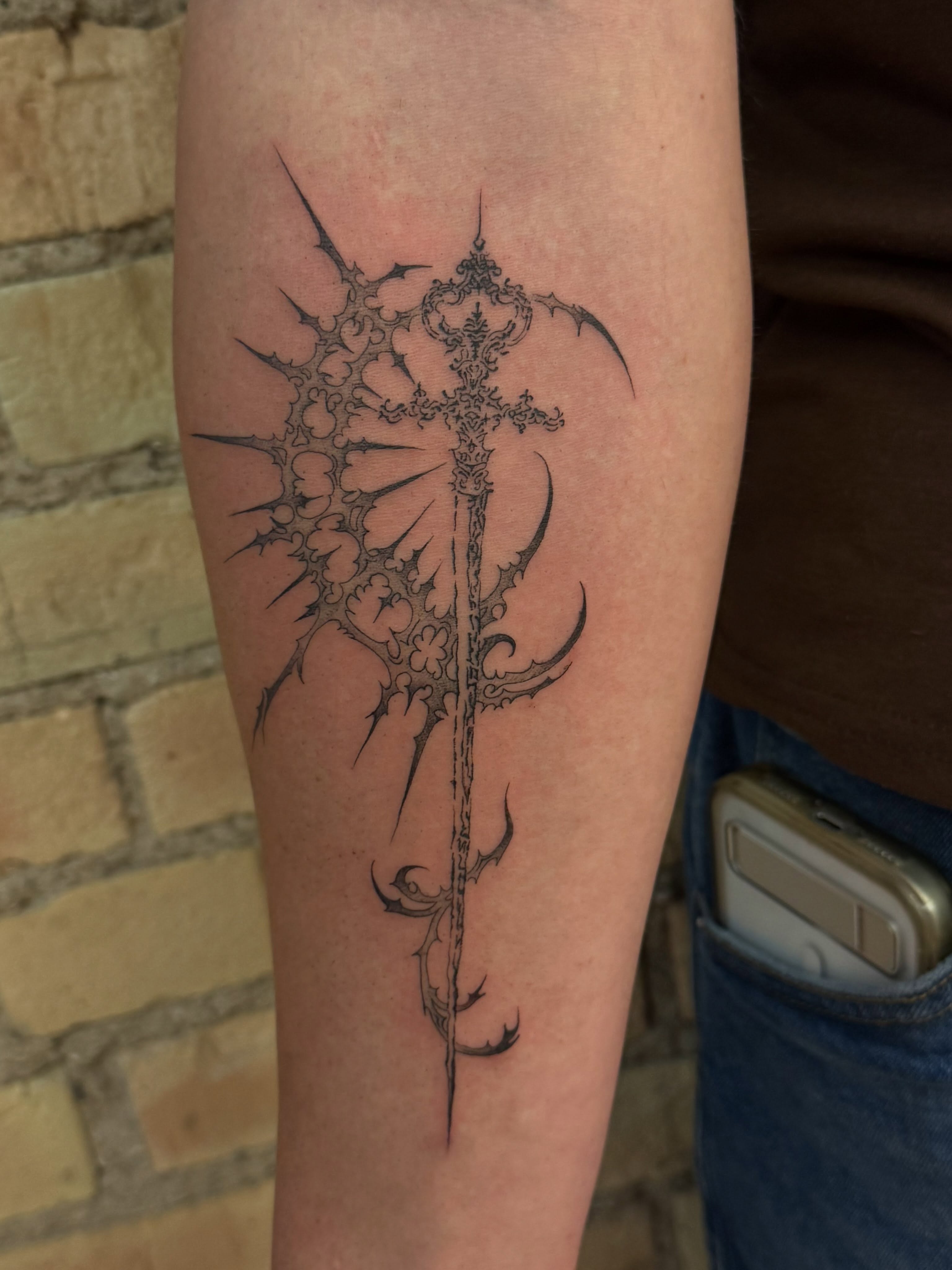Cross with thorns black and grey tattoo on the forearm by Dre