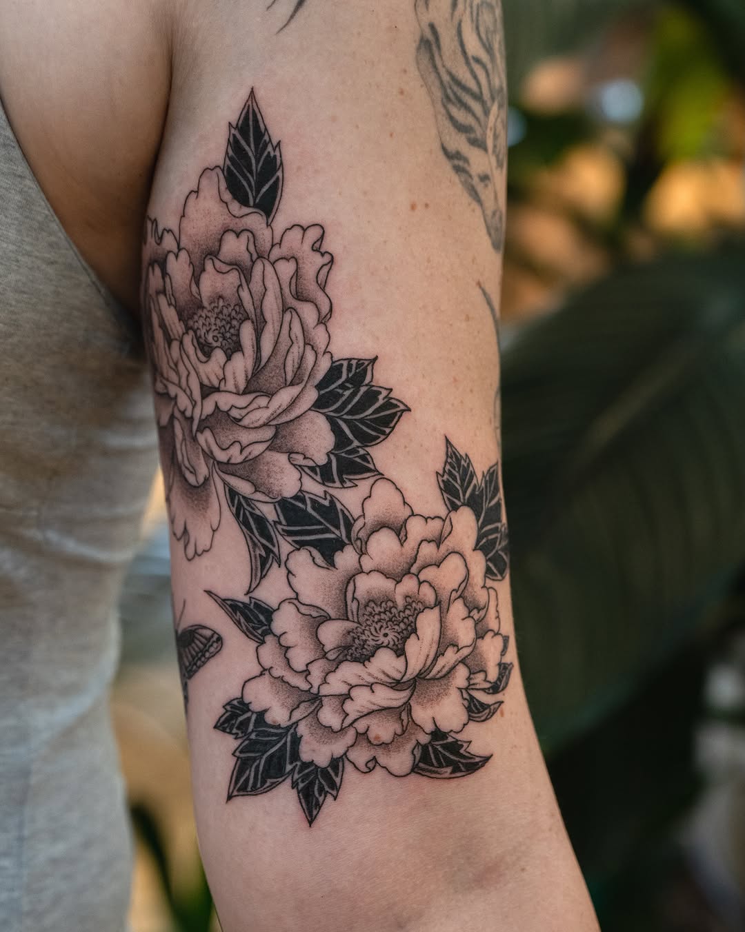 Peony flowers black and grey tattoo on the forearm by James Fernella, San Francisco, California