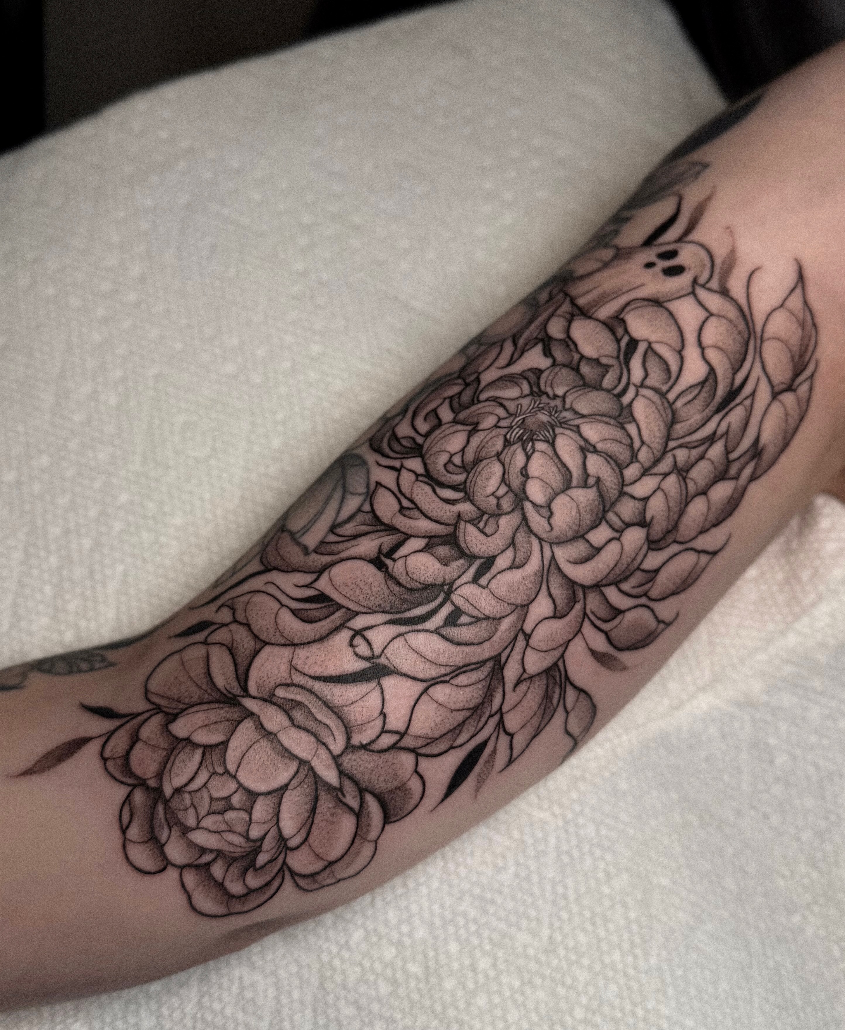 Chrysanthemum black and grey tattoo on the forearm by Jessica Bloom