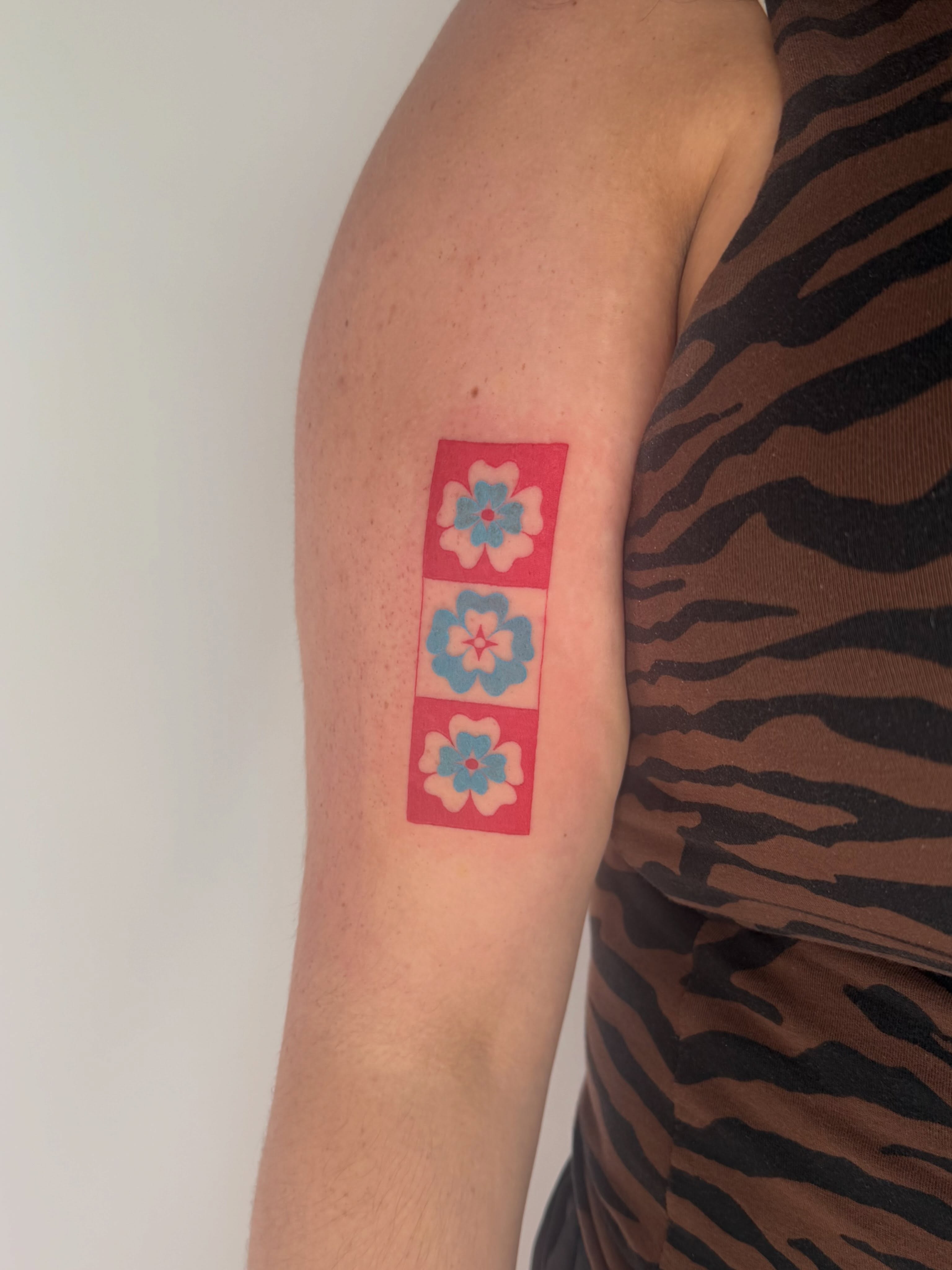 Flowers geometric tattoo on the forearm by Leah Ramos