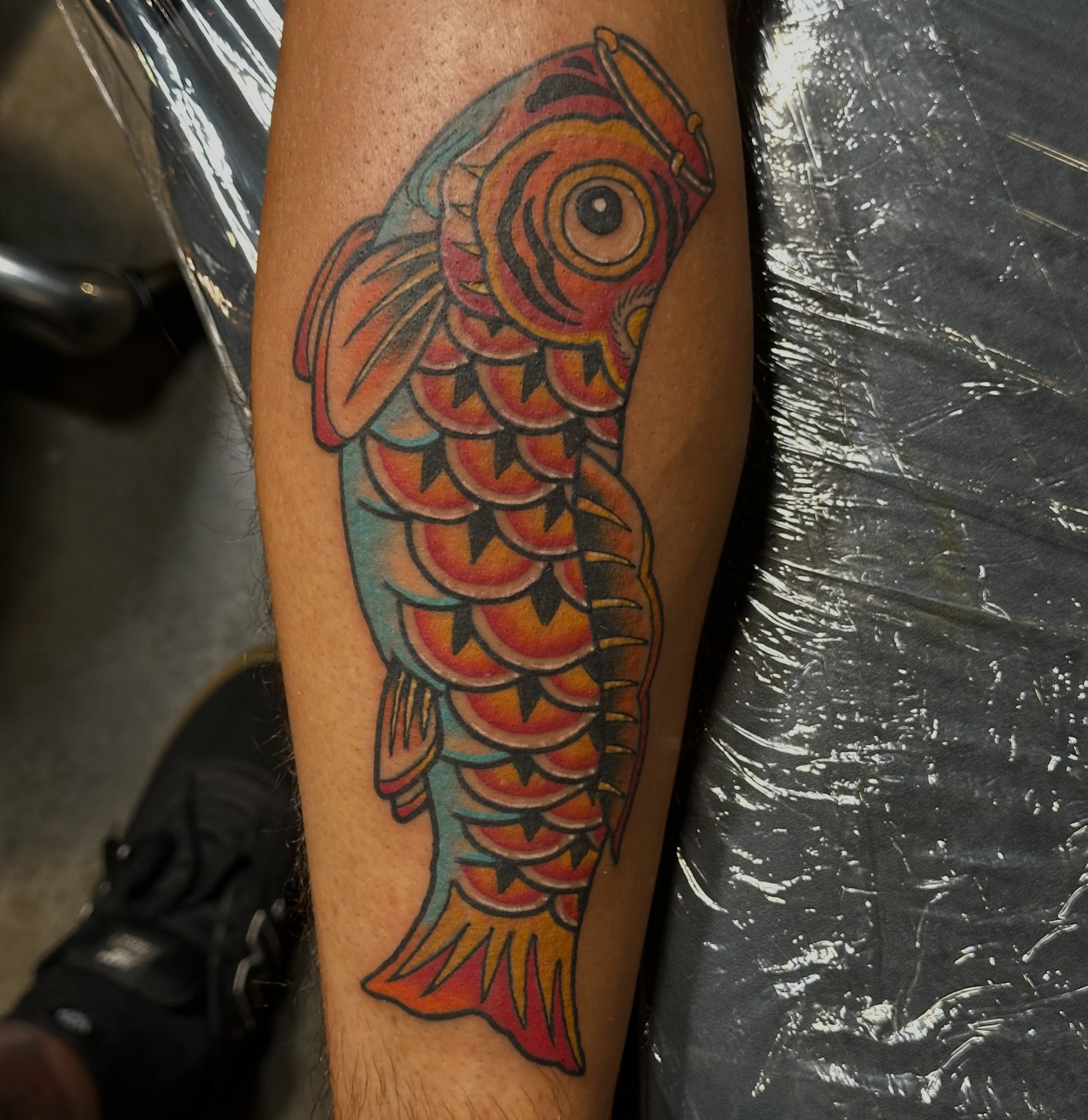 Koi fish American traditional tattoo on the forearm by Wesley Lam