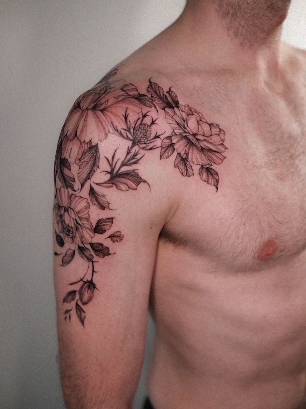 Floral arrangement black and grey tattoo on the shoulder by Temple Adorned Tattoo