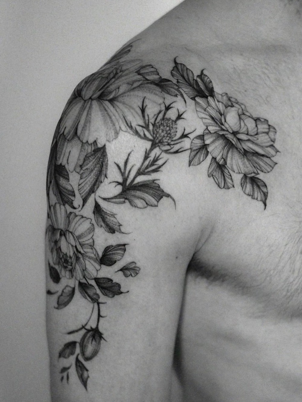 Floral arrangement black and grey tattoo on the shoulder by Temple Adorned Tattoo