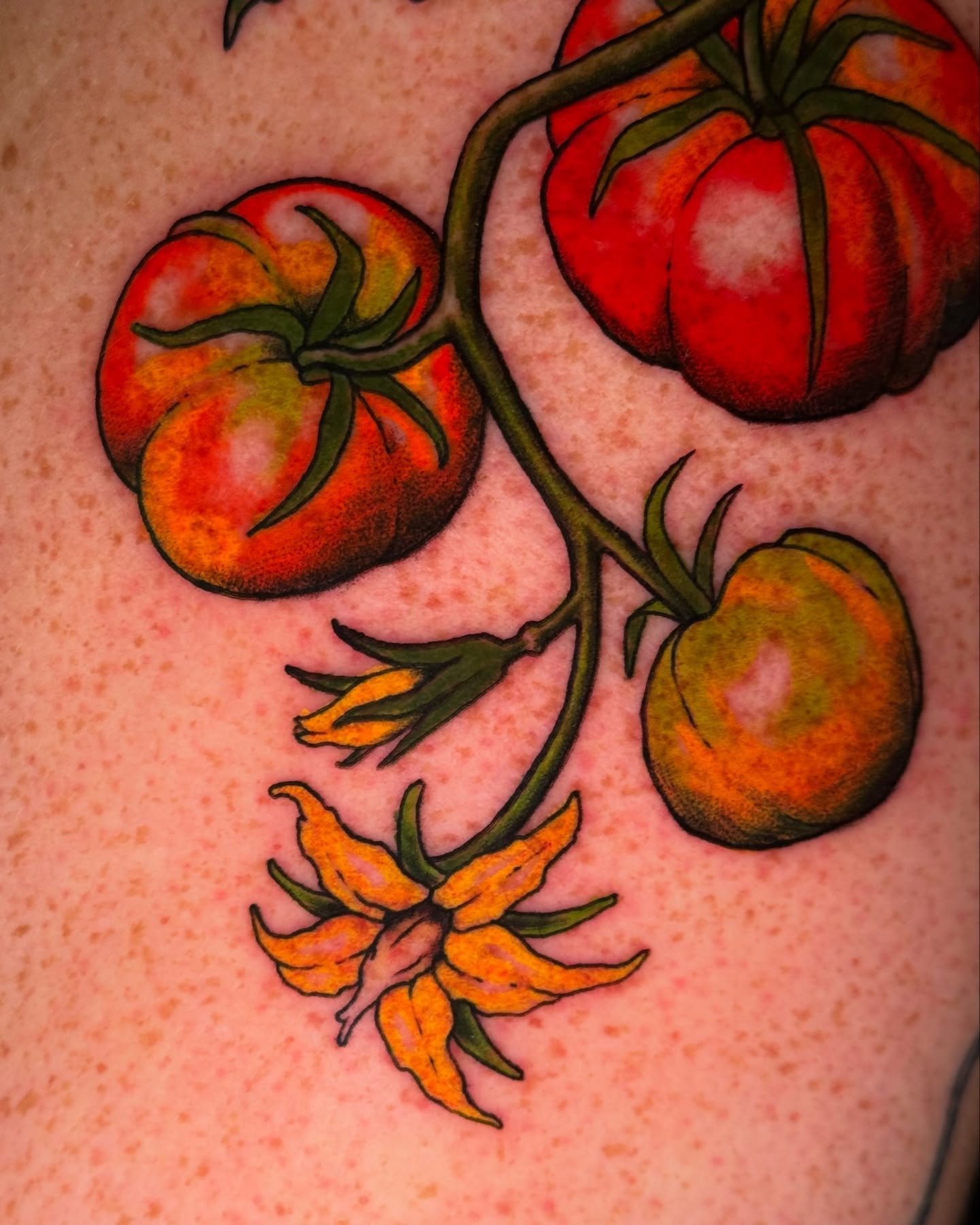 Tomatoes and flowers American traditional tattoo on the torso by marlena borscheid