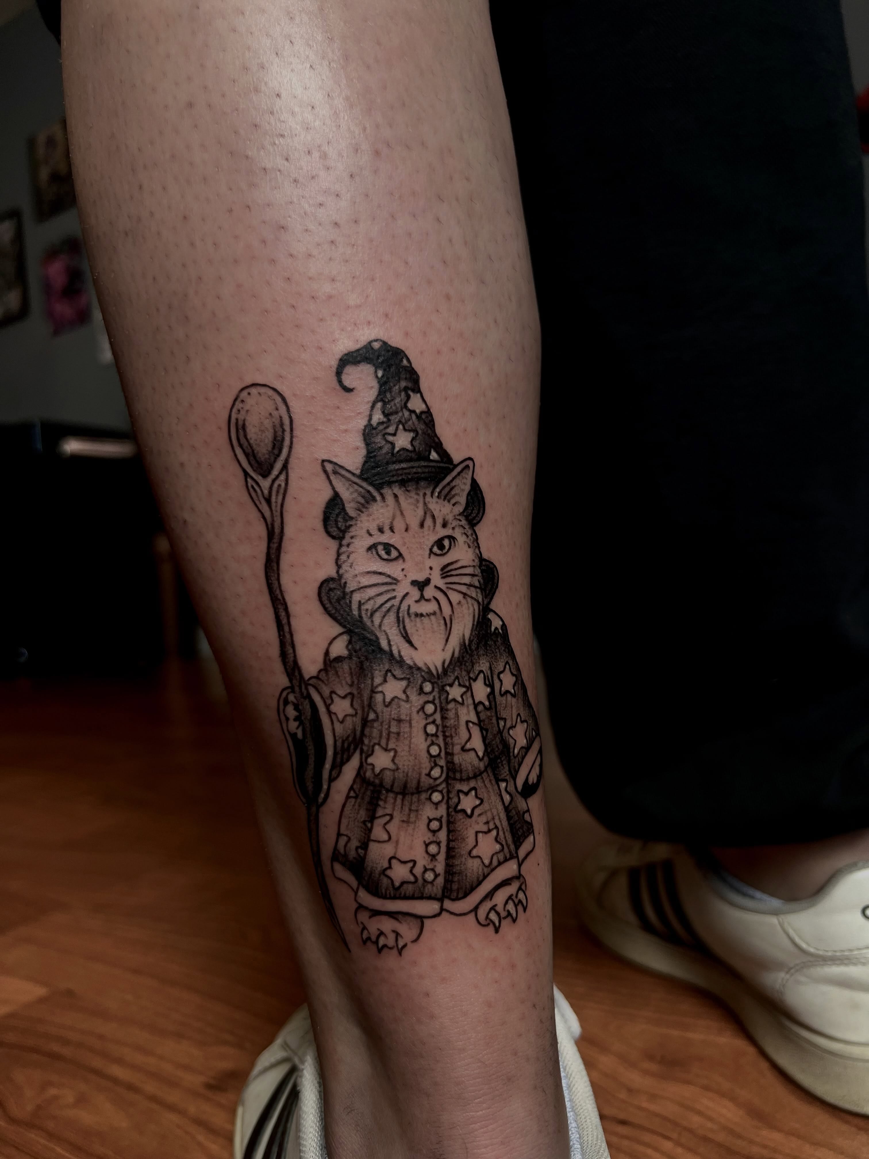 Cat wizard black and grey tattoo on the forearm by Ady Paige
