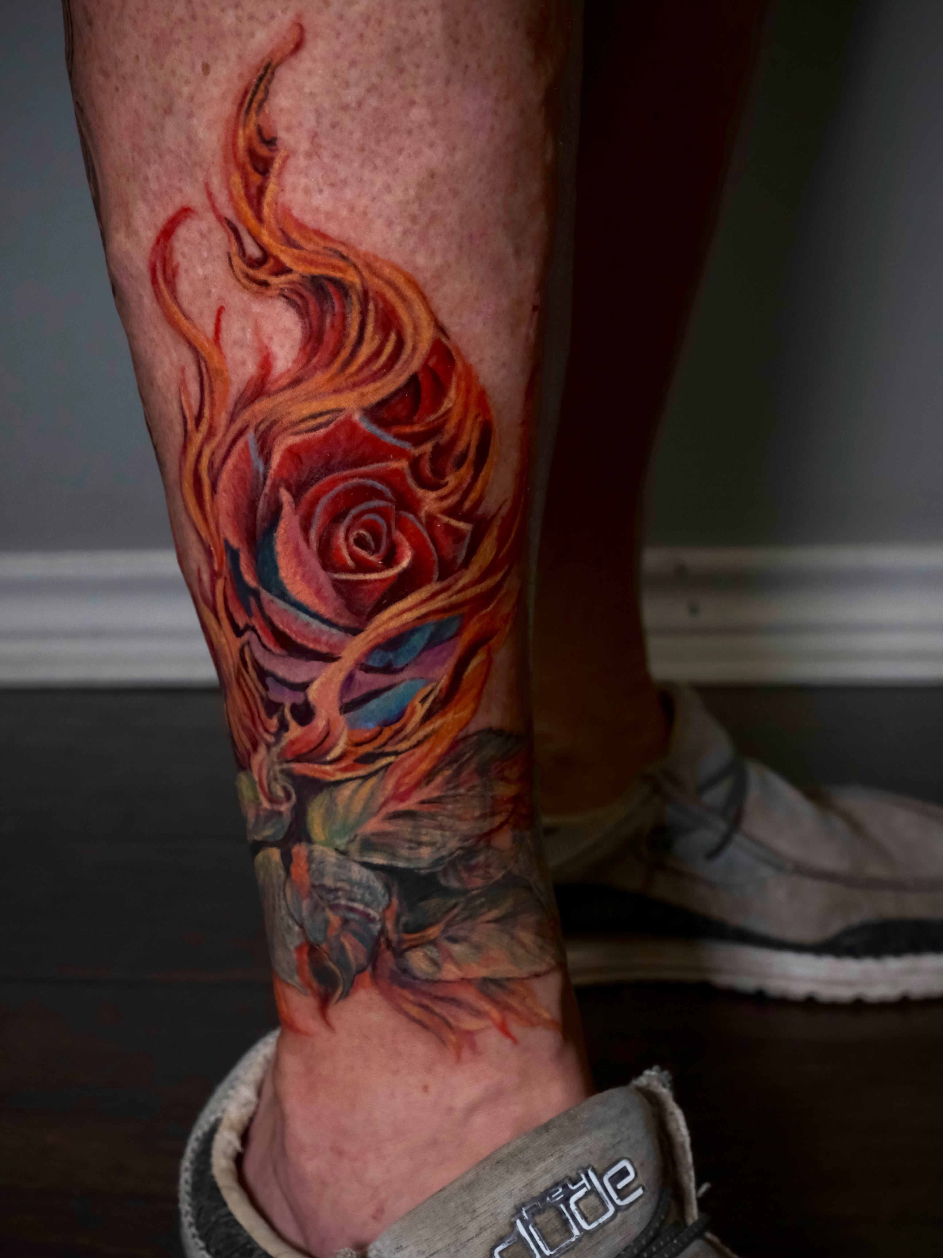 Flaming rose watercolor tattoo on the calf by AL 777, Denton, Texas