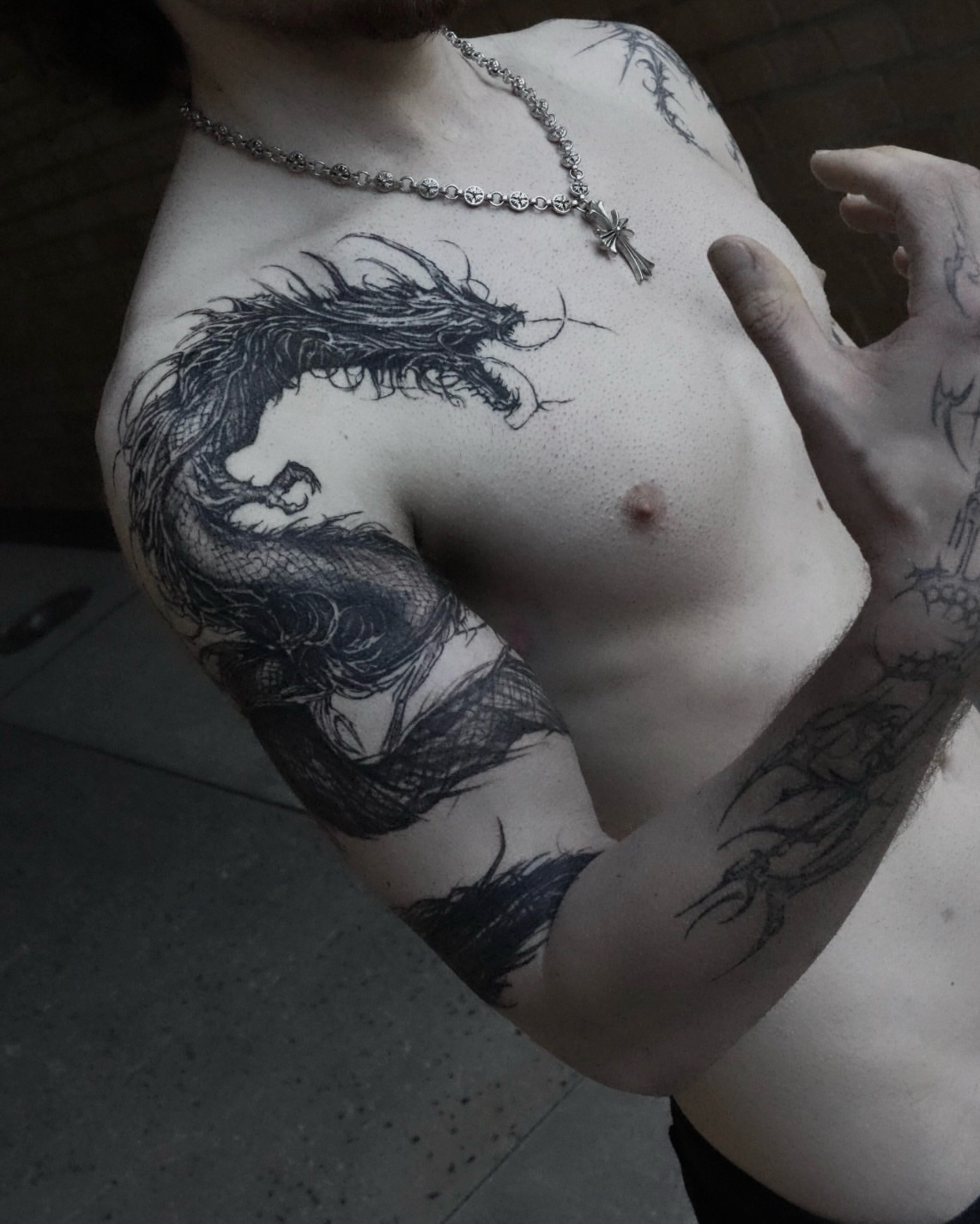 Dragon black and grey tattoo on the chest by Gun