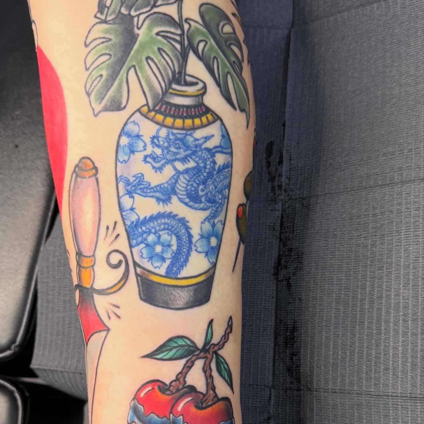 Vase with dragon American traditional tattoo on the forearm by Isaac Ortiz-Riendeau