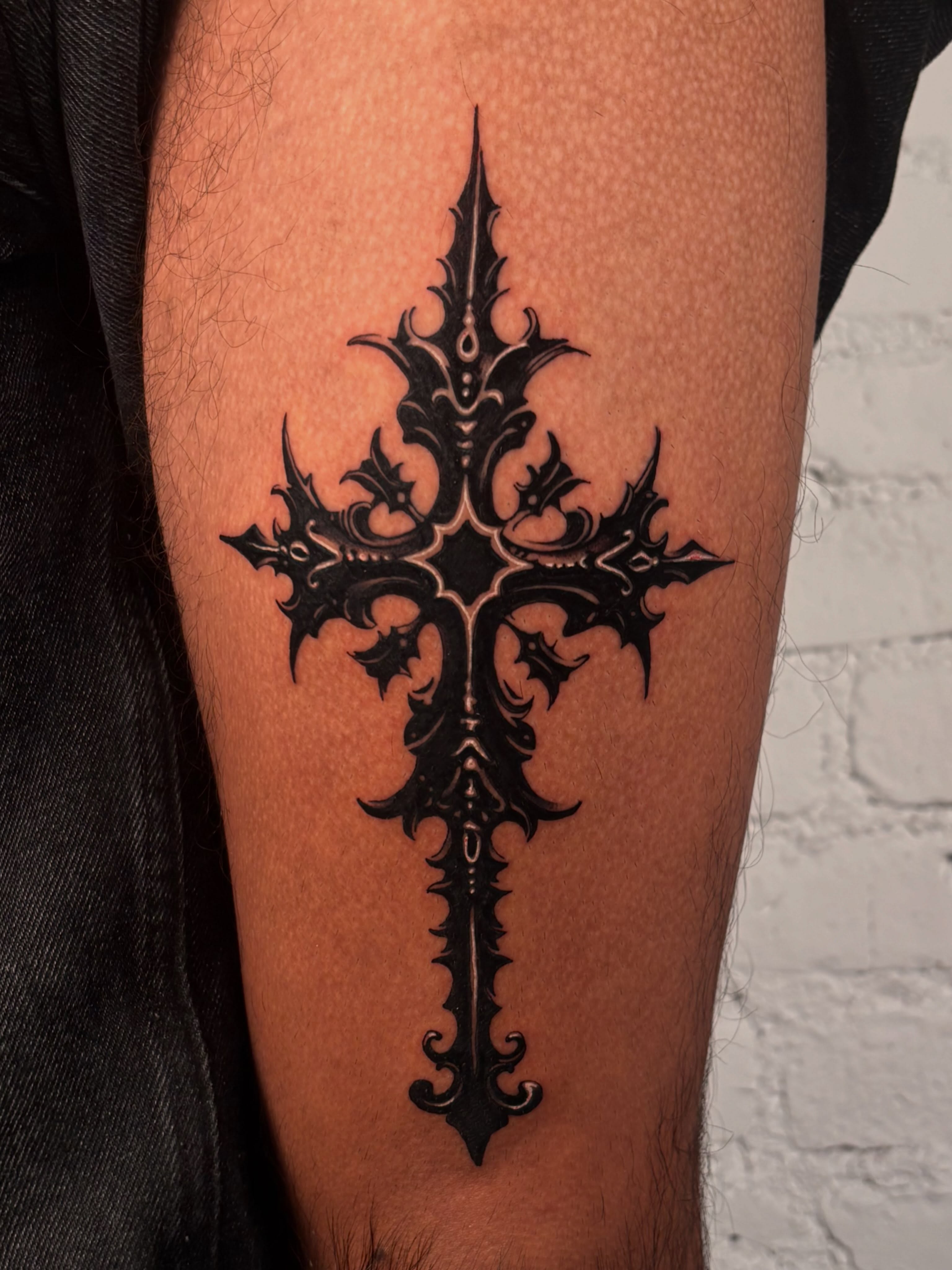 Cross blackwork tattoo on the thigh by laura bianca