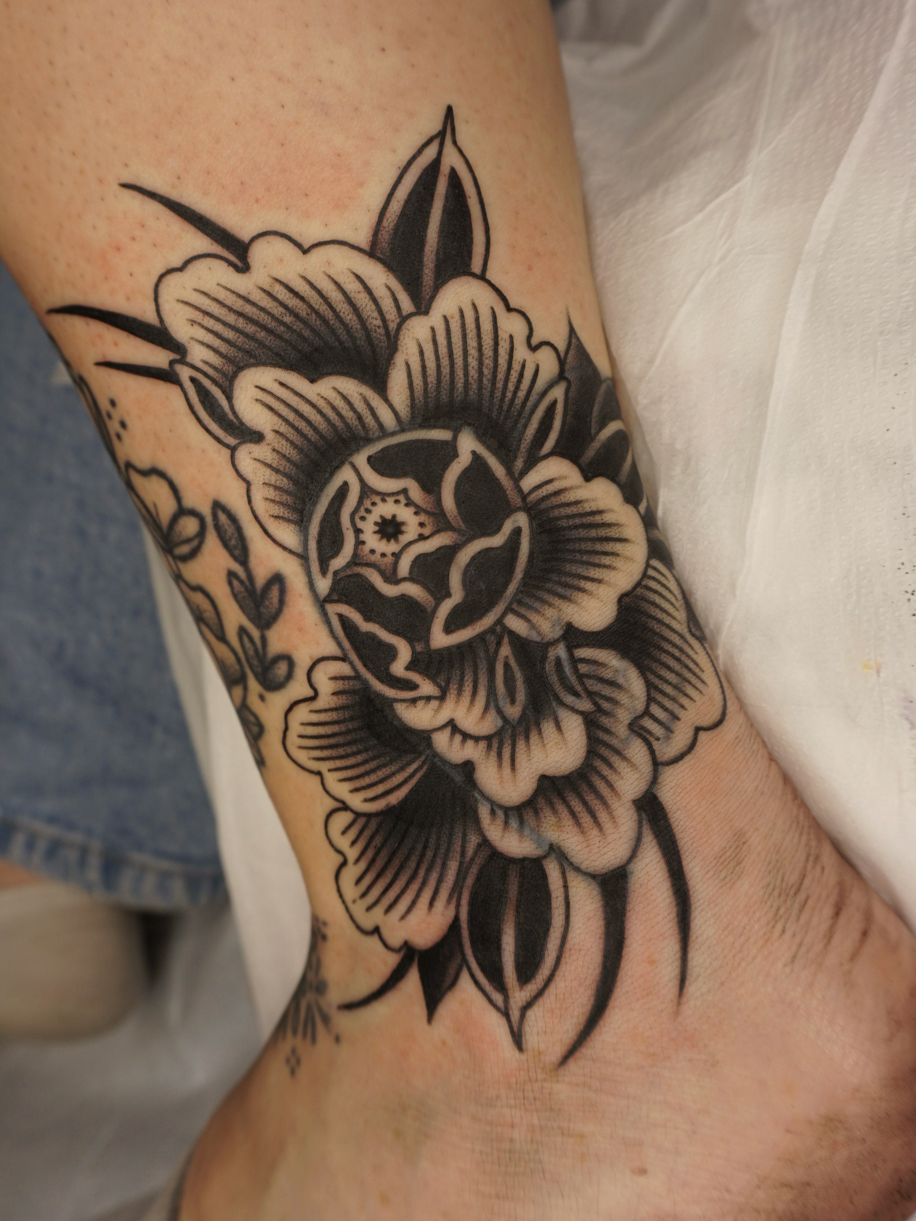 Floral bouquet American traditional tattoo on the forearm by Sarah Christine Tattoo, Calgary, Alberta