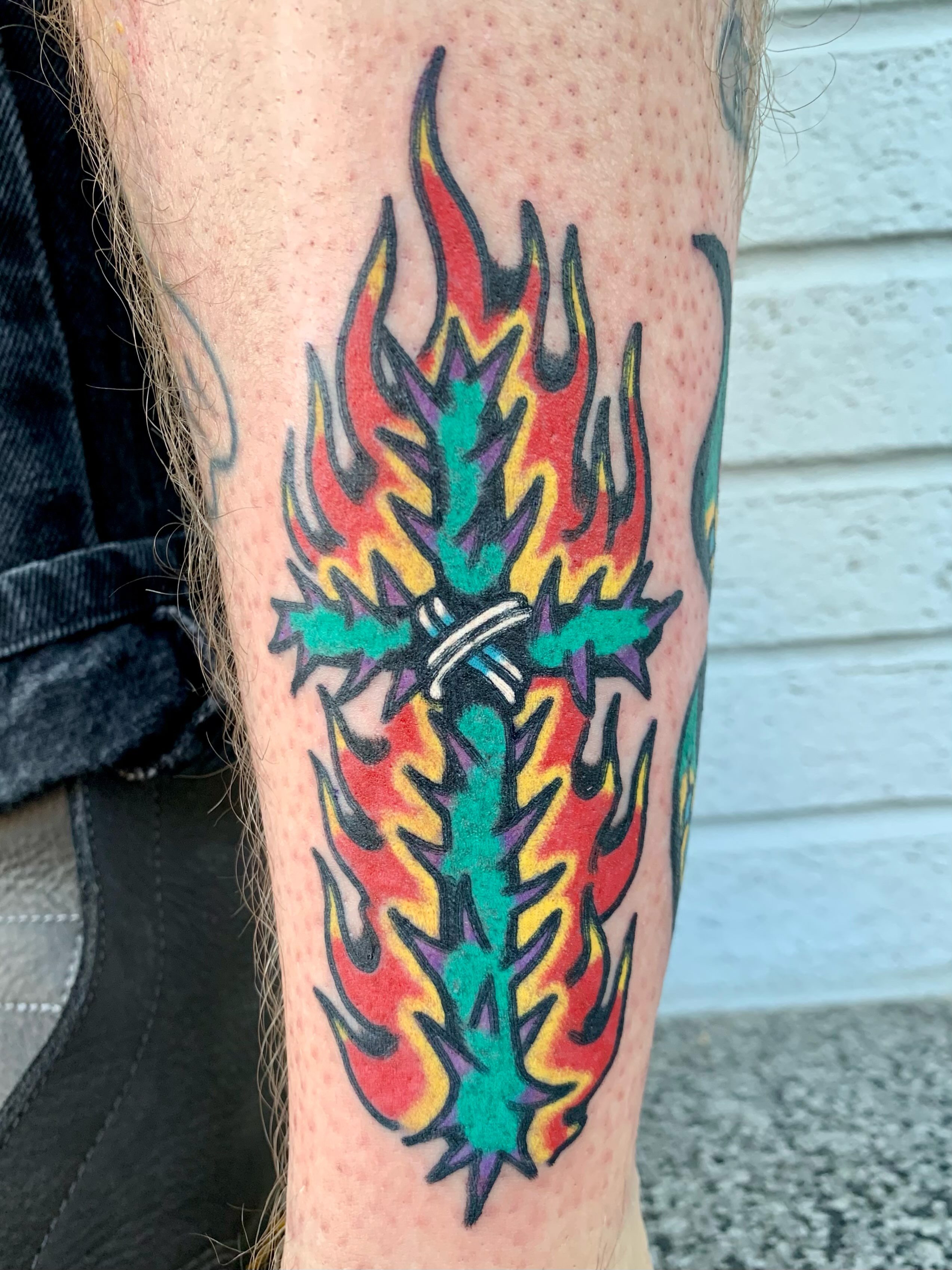 Flame cross American traditional tattoo on the forearm by Keegan Bergen