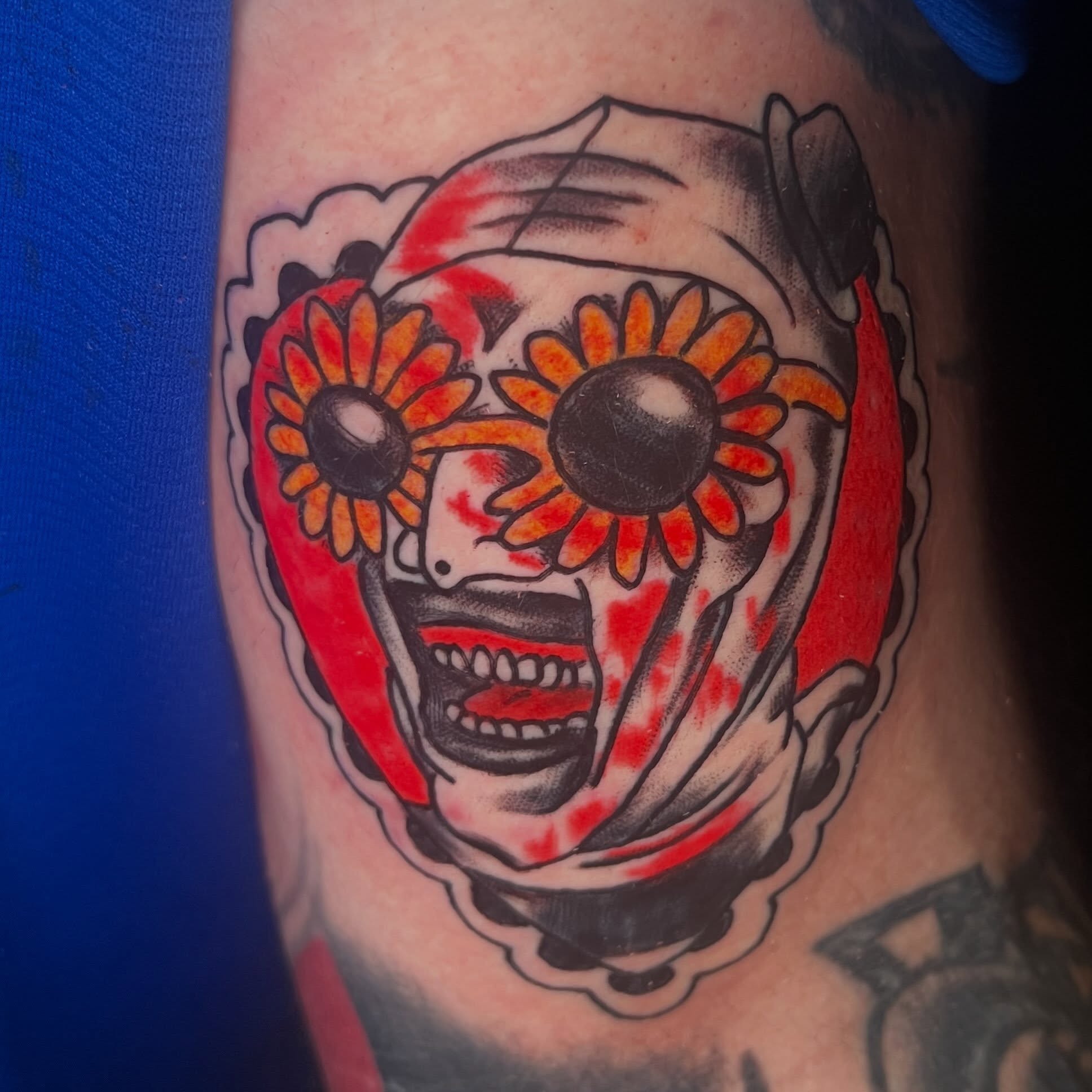 Clown face with flowers American traditional tattoo on the forearm by Davidsteeletattoos, Dallas, Texas