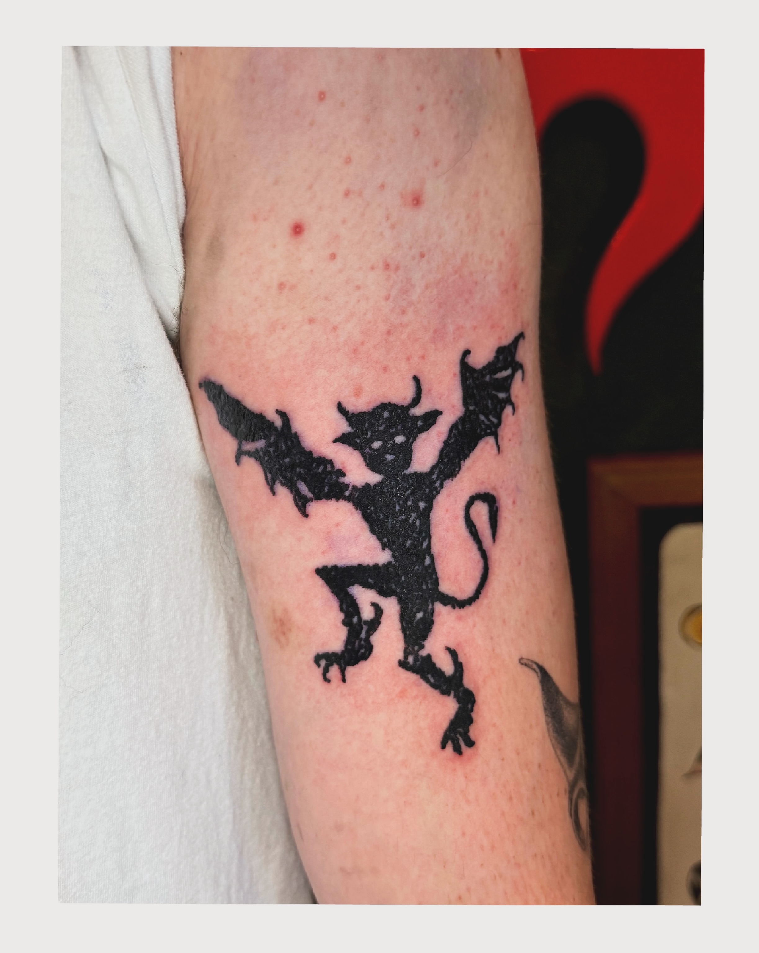 Winged creature blackwork tattoo on the forearm by Noah Vincent Tattoo, Vancouver, Washington