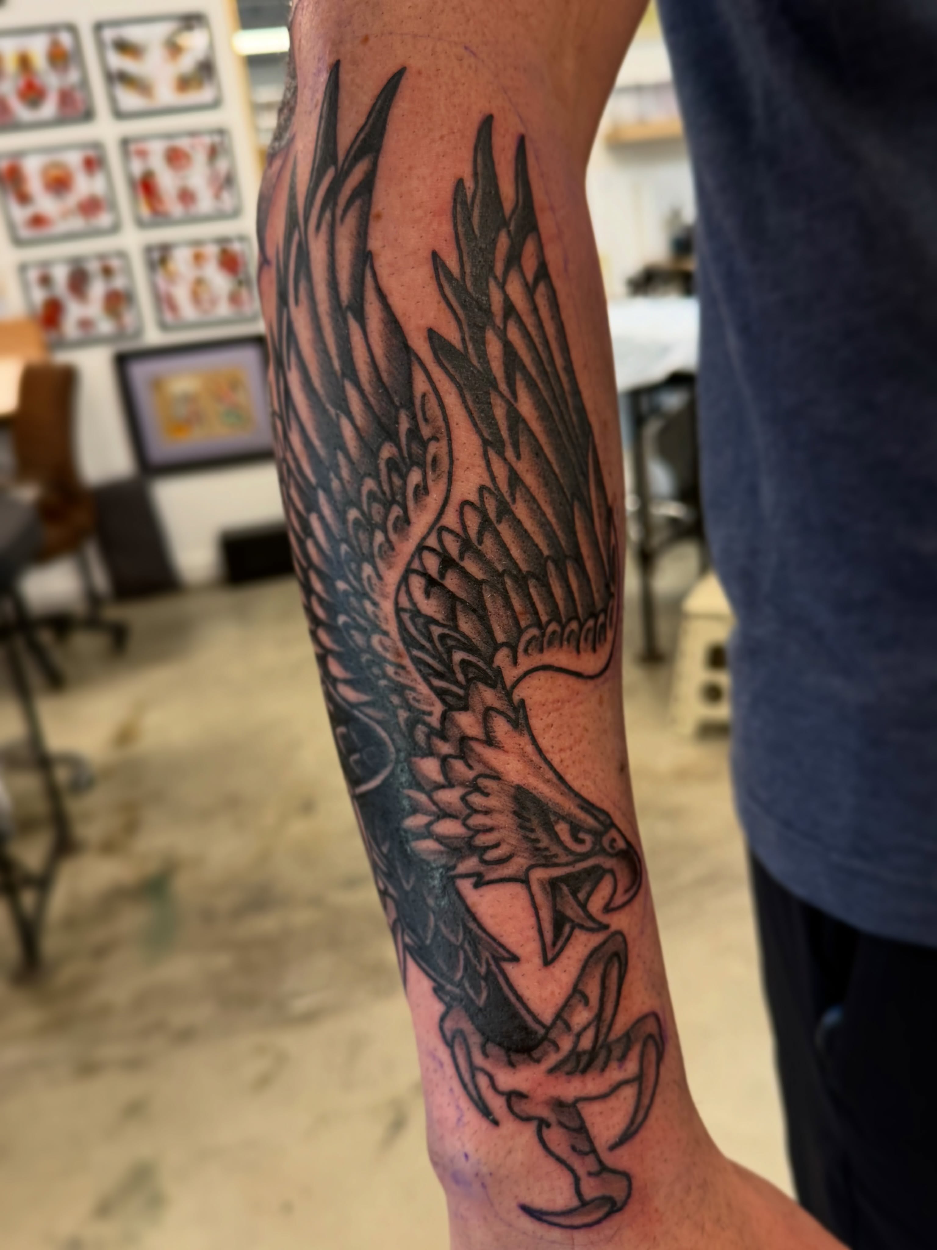 Eagle black and grey tattoo on the forearm by Christopher Layman