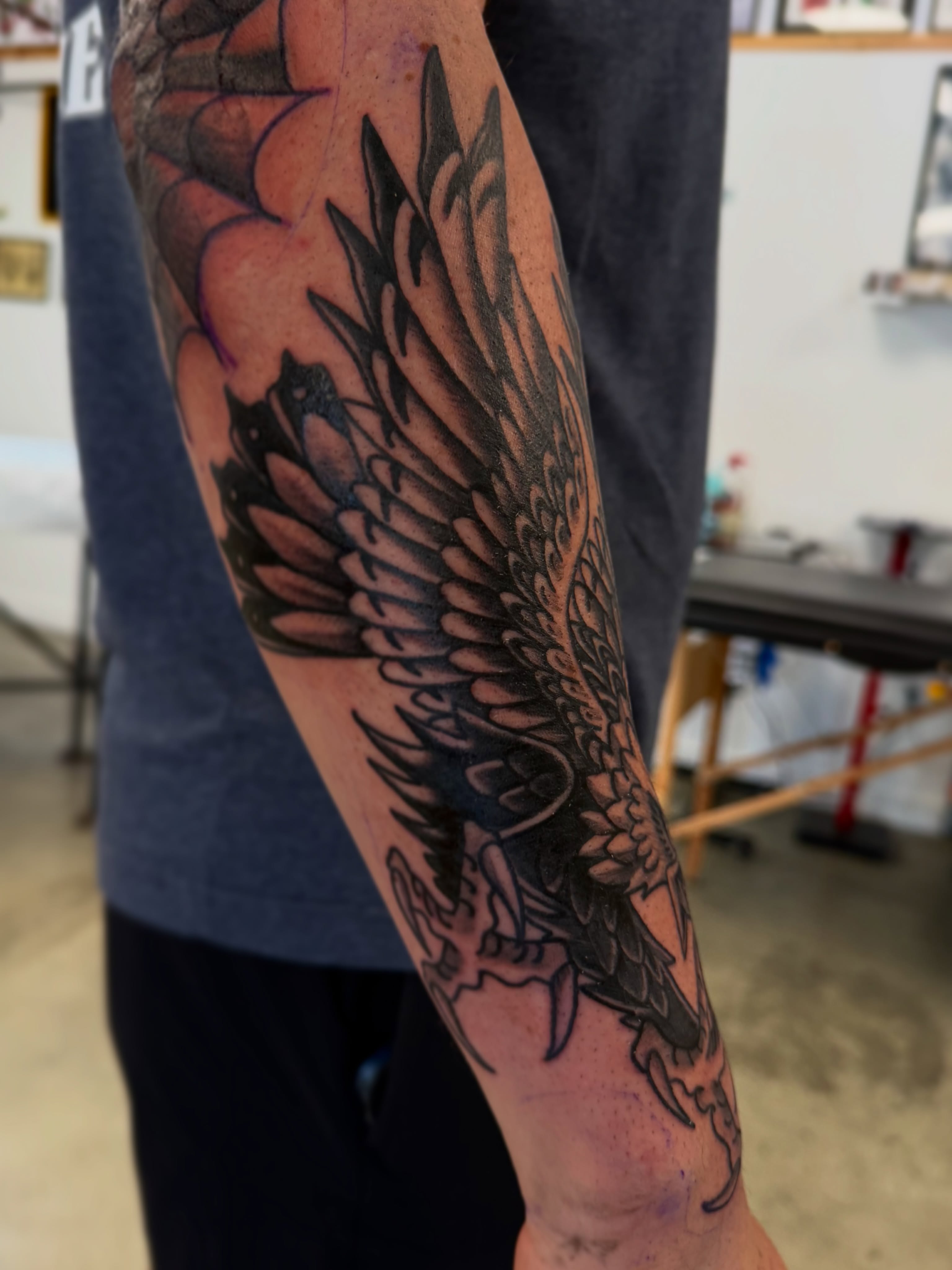 Eagle black and grey tattoo on the forearm by Christopher Layman