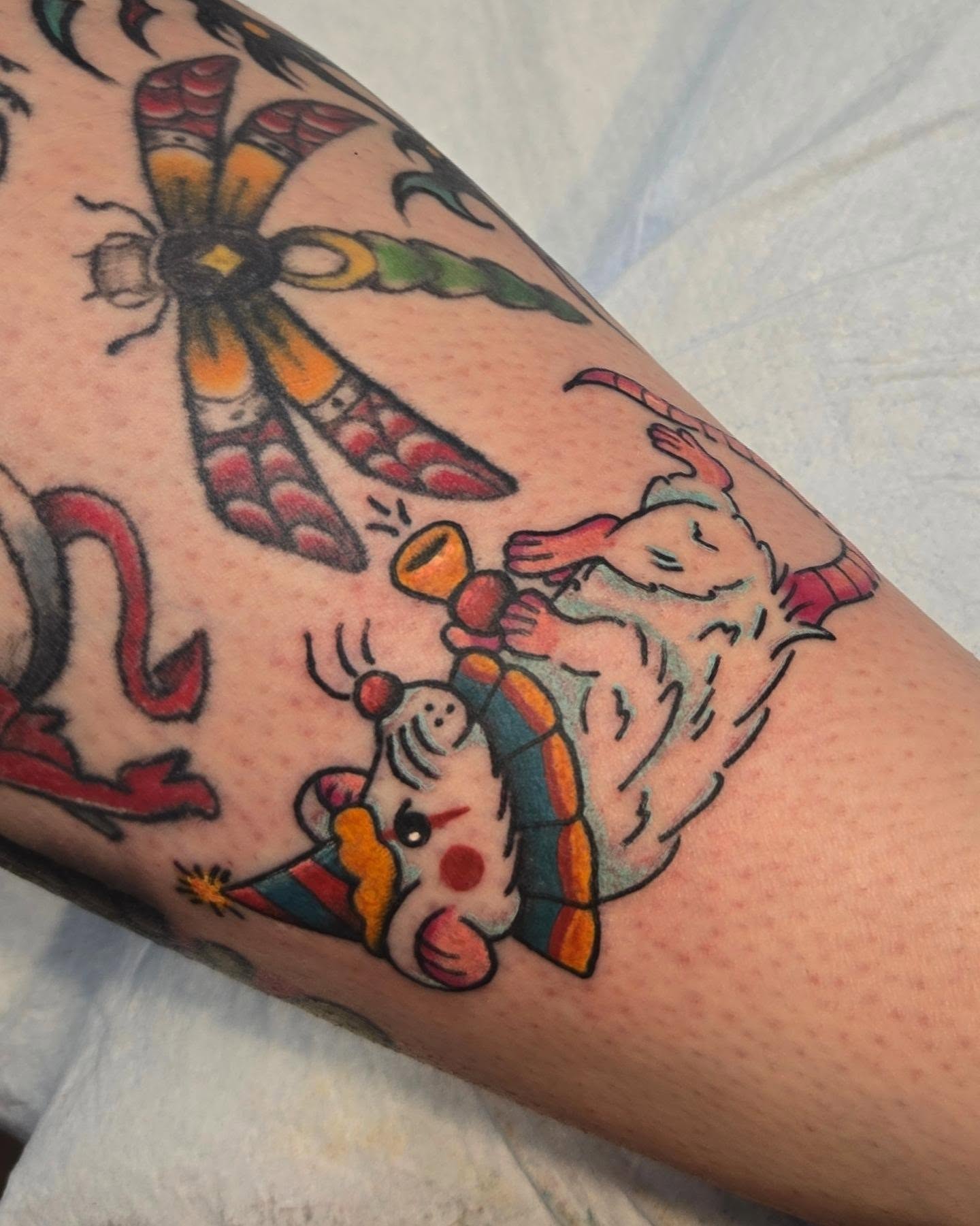 Clown and dragonfly American traditional tattoo on the forearm by Abigail (Bgail) Boyd