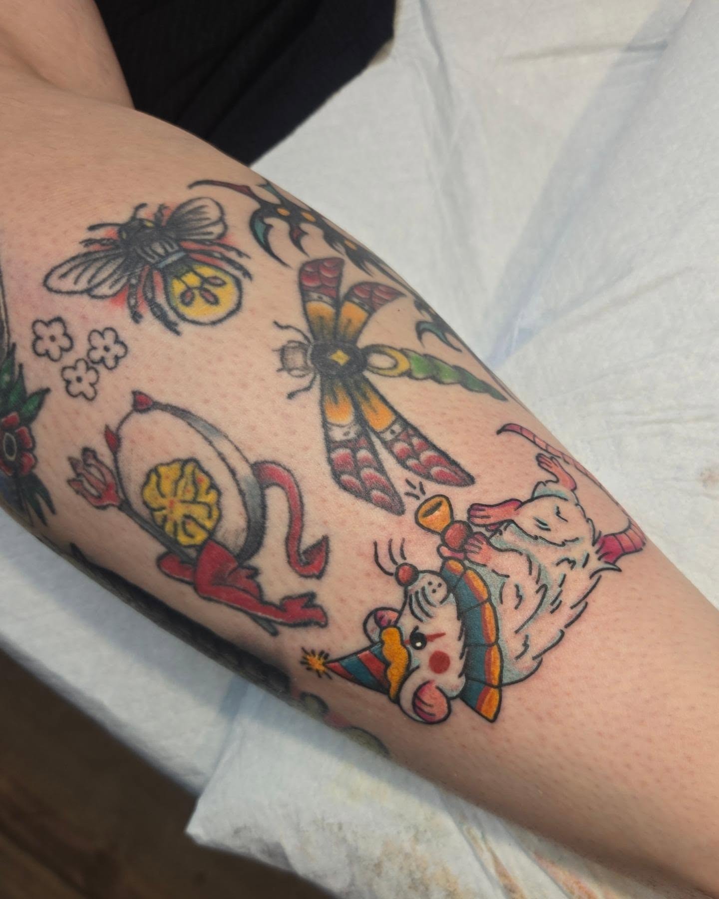 Clown and dragonfly American traditional tattoo on the forearm by Abigail (Bgail) Boyd