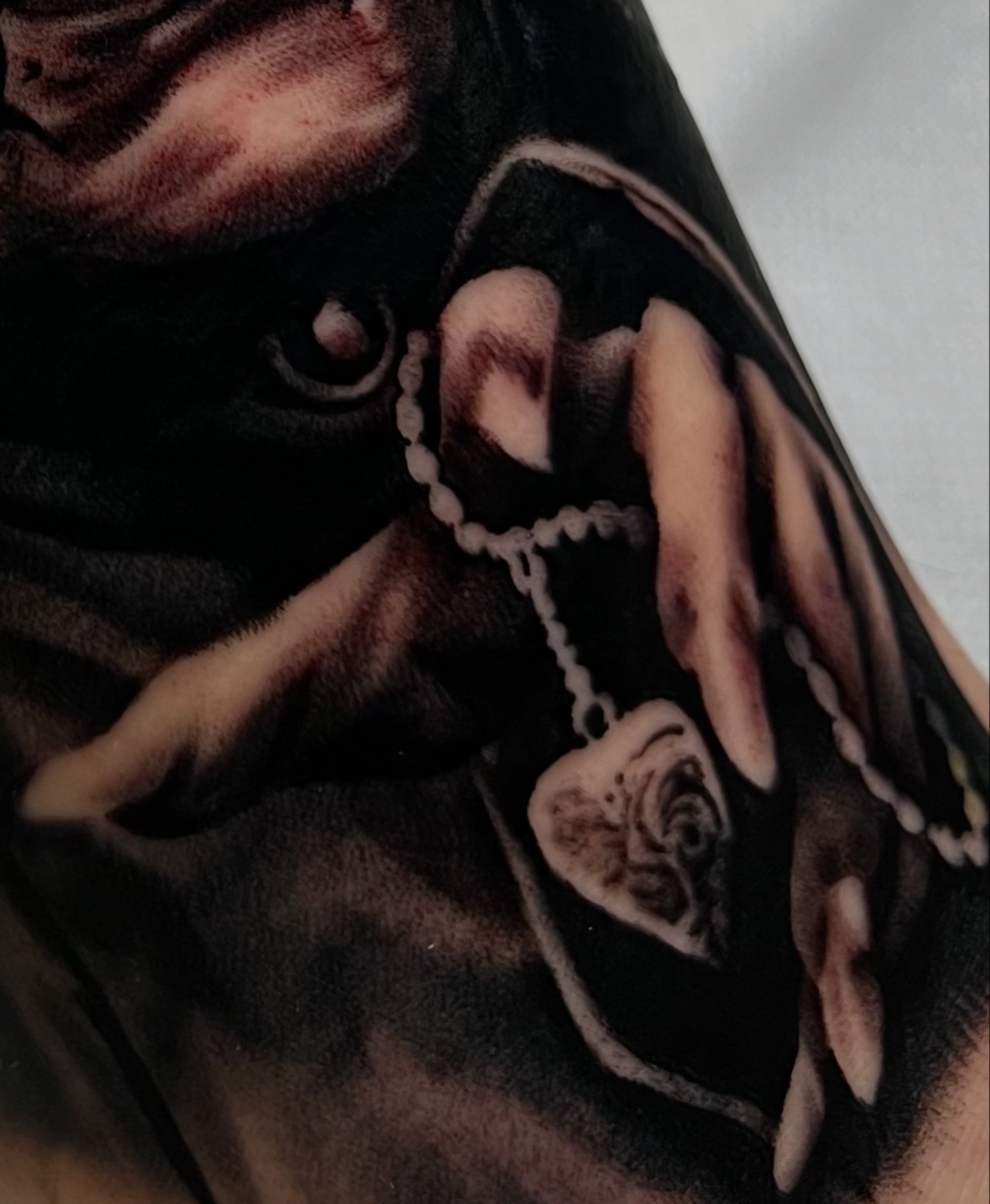 Roses and cross realism tattoo on the upper arm by James Foltz