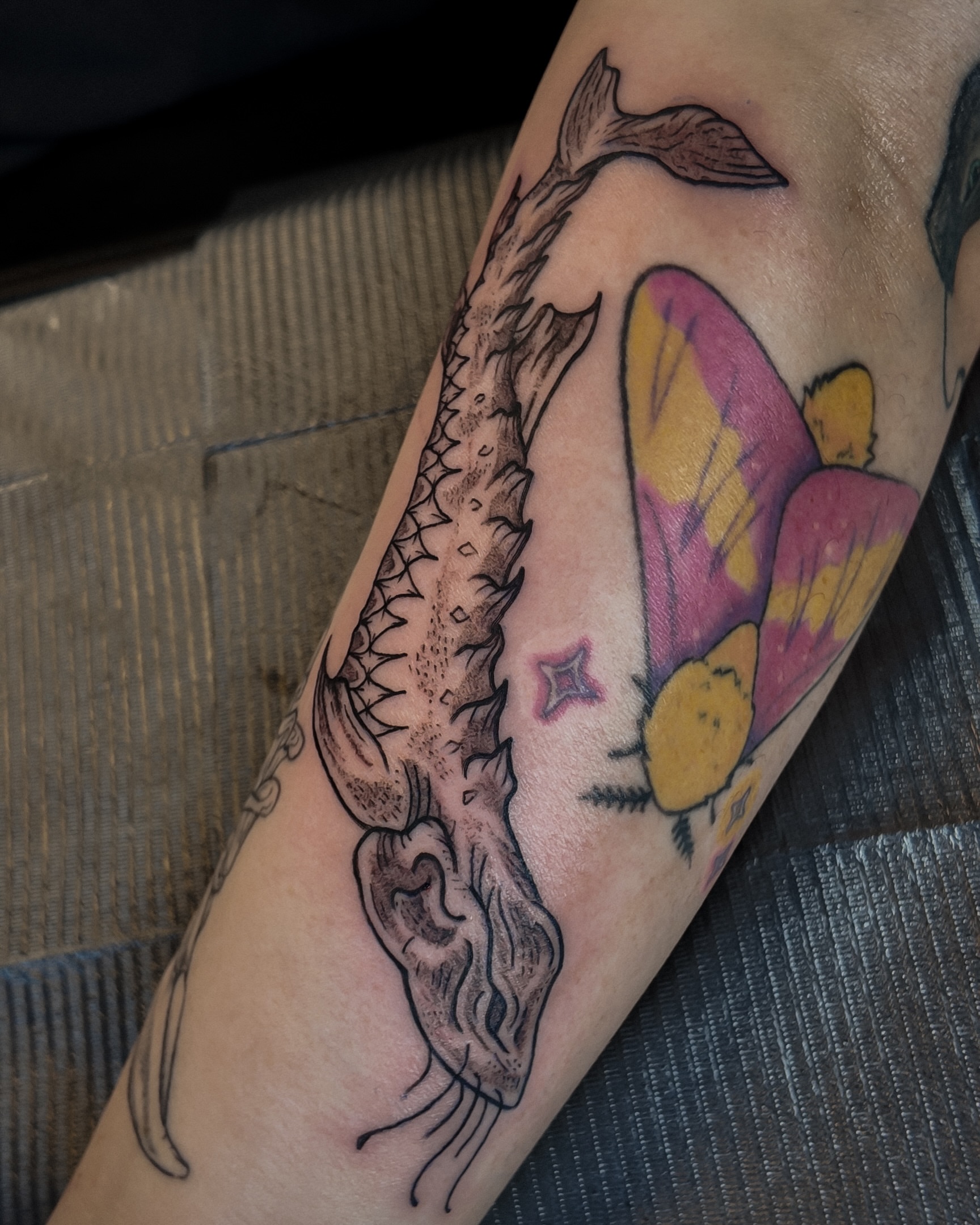 Fish and butterfly dotwork tattoo on the forearm by Morgan Diann