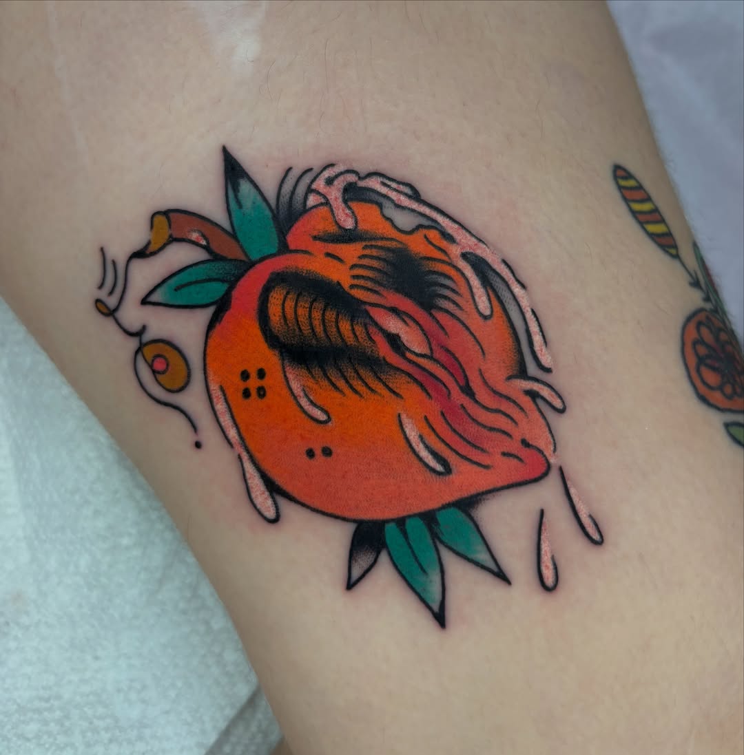 Peach American traditional tattoo on the thigh by ericka bates