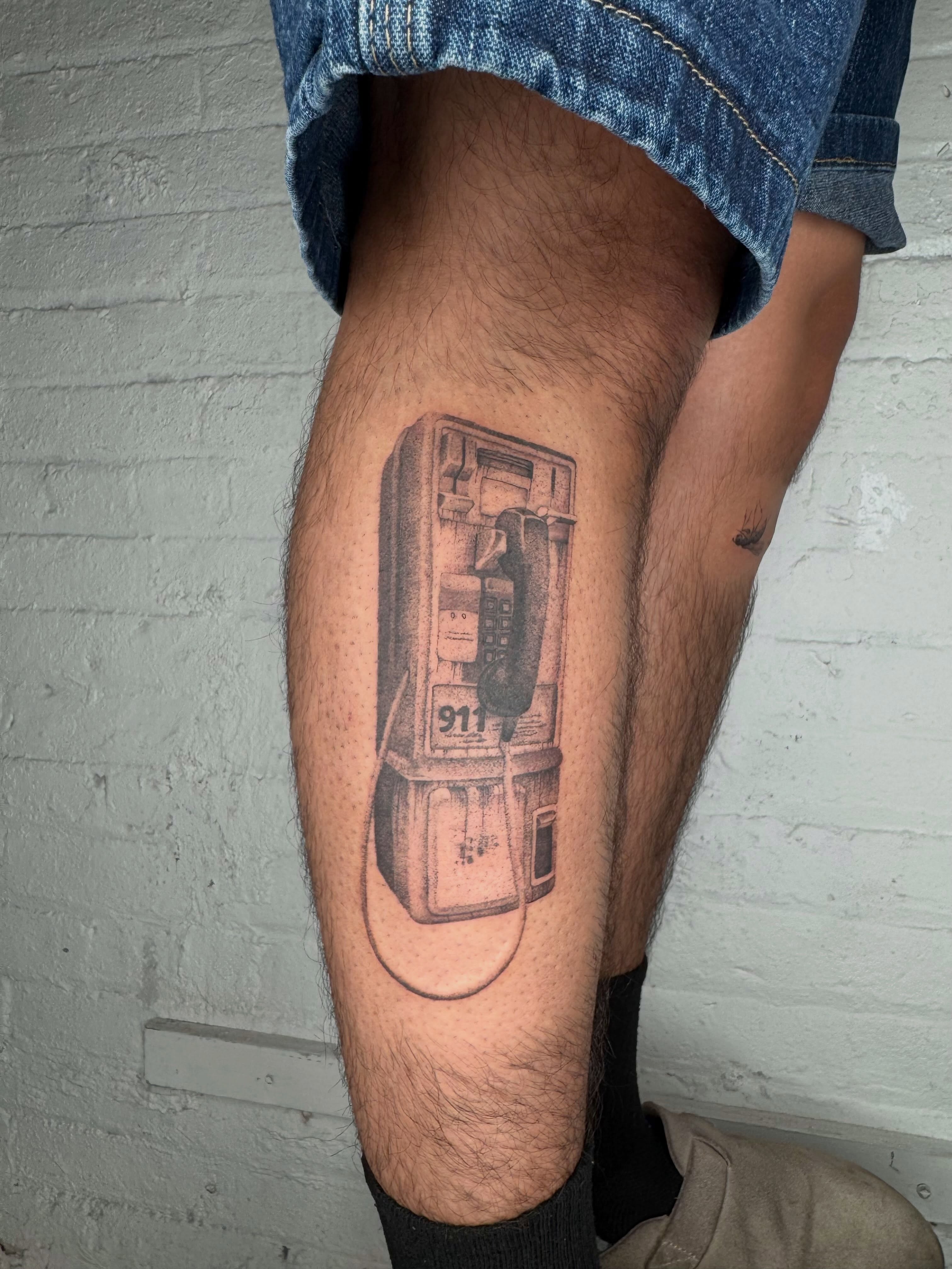 Payphone black and grey tattoo on the thigh by Kenny ๐ด