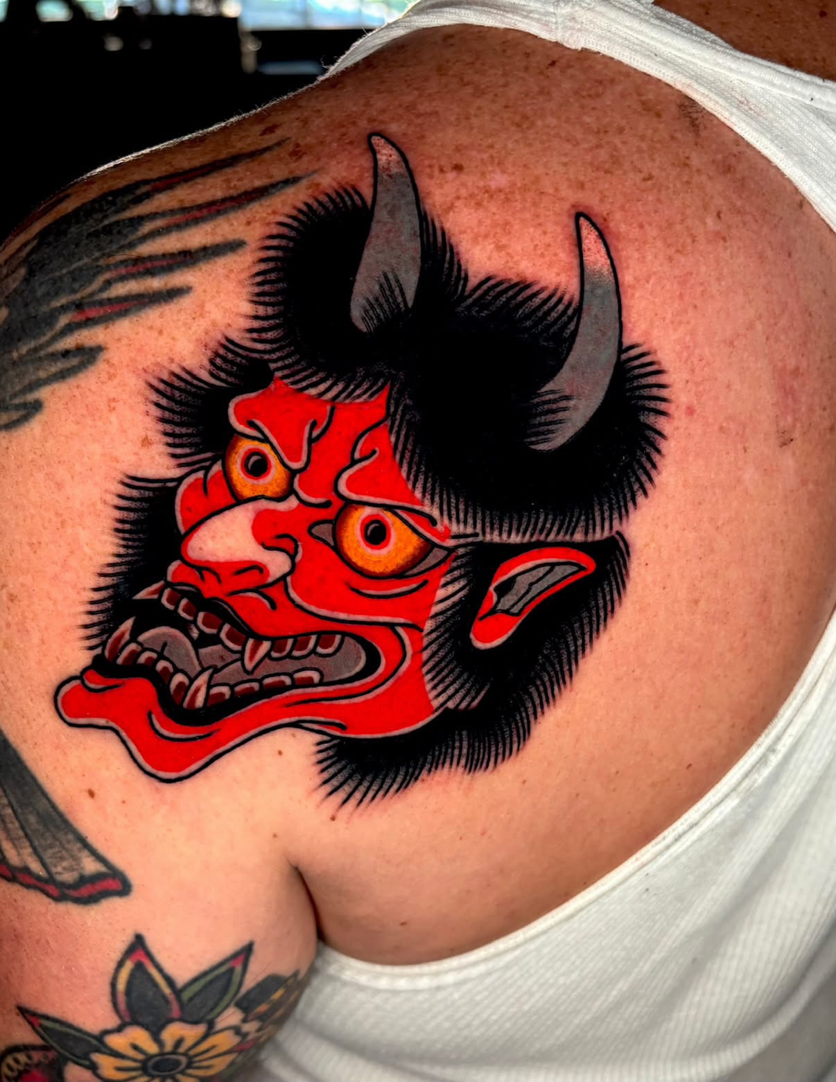 Demon mask American traditional tattoo on the shoulder by Alex Muniz