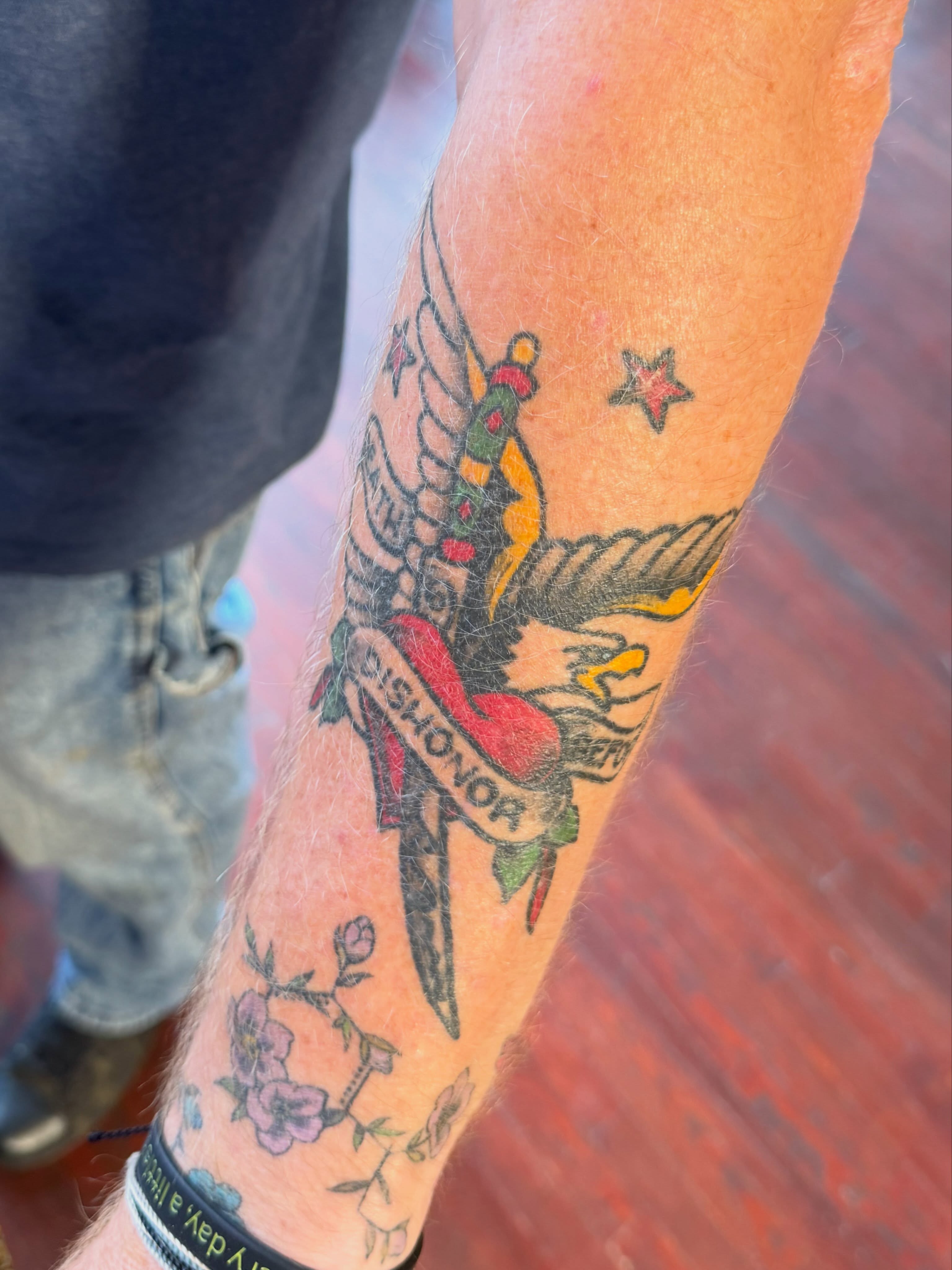 Winged angel with banner American traditional tattoo on the forearm by Evan Voelker