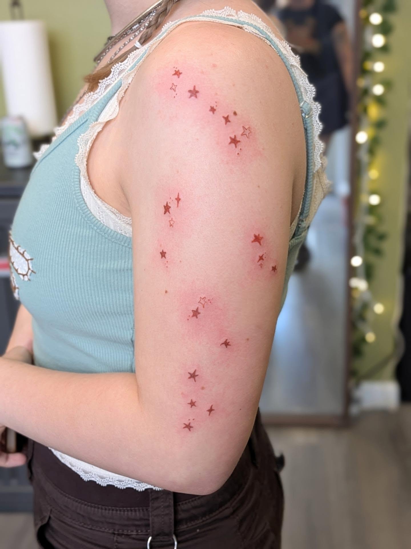 Stars dotwork tattoo on the upper arm by Ryan