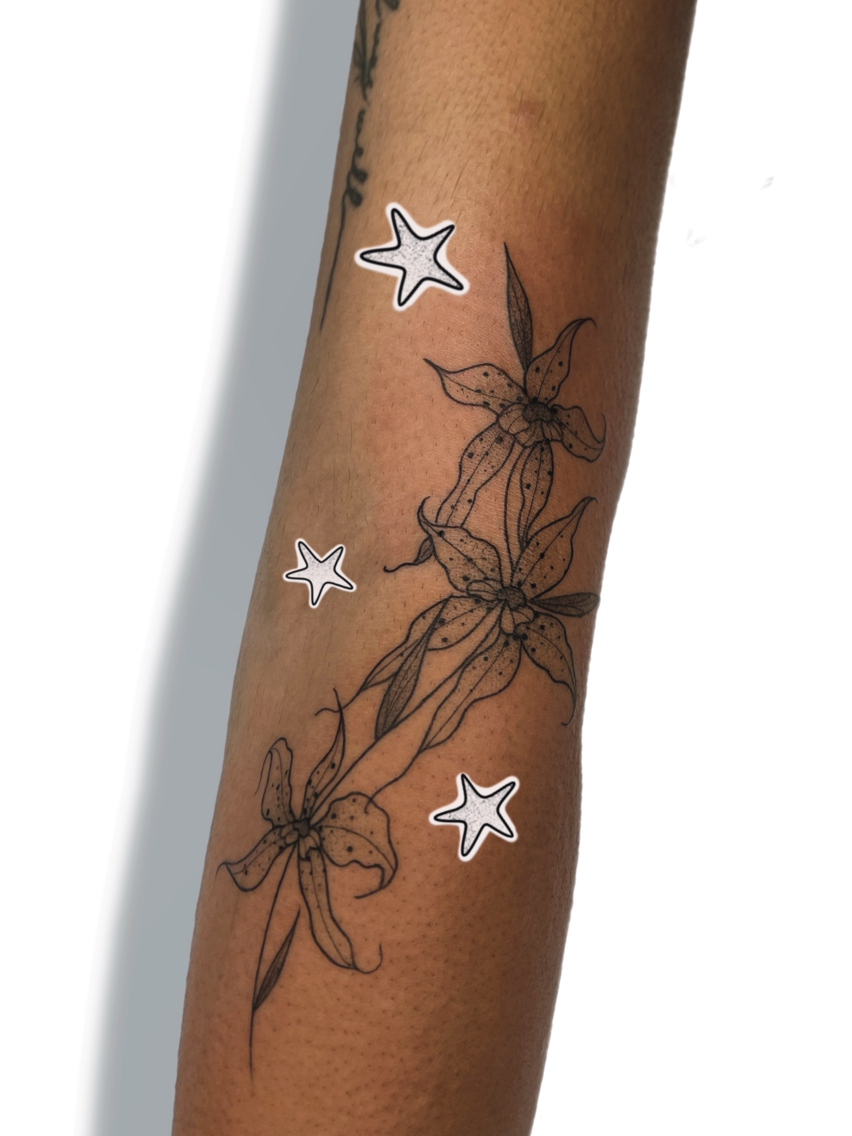Lilies and stars black and grey tattoo on the forearm by Jules ๐โโฌ, Chicago, Illinois