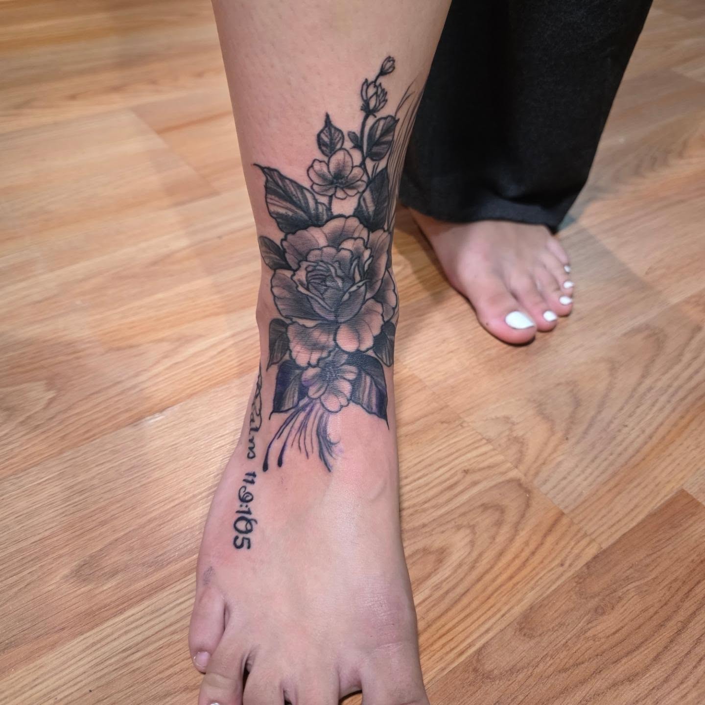 Floral bouquet black and grey tattoo on the calf by Rusty Williams