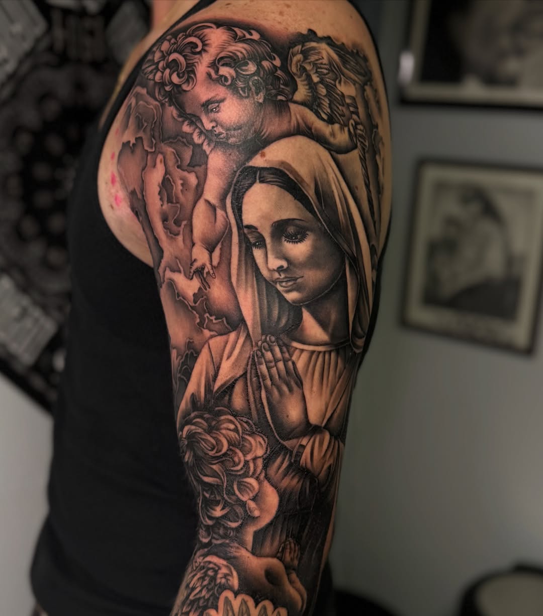 Religious scene realism tattoo on the upper arm by San Diego Tattoo Artist