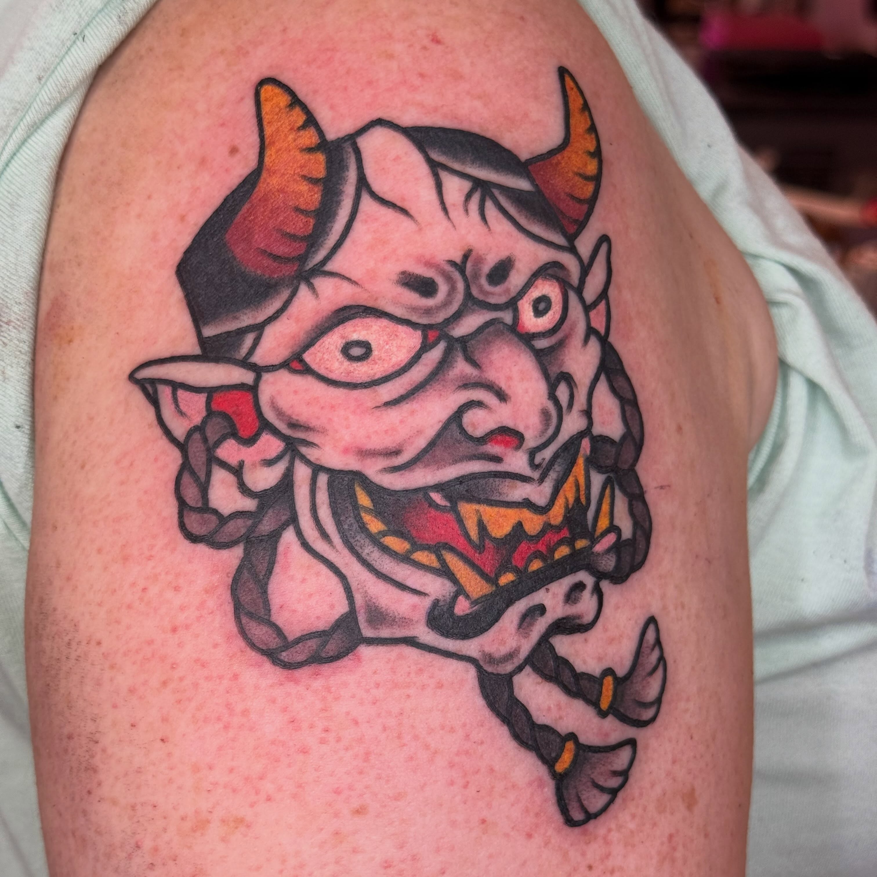 Demon mask American traditional tattoo on the shoulder by clay🚀
